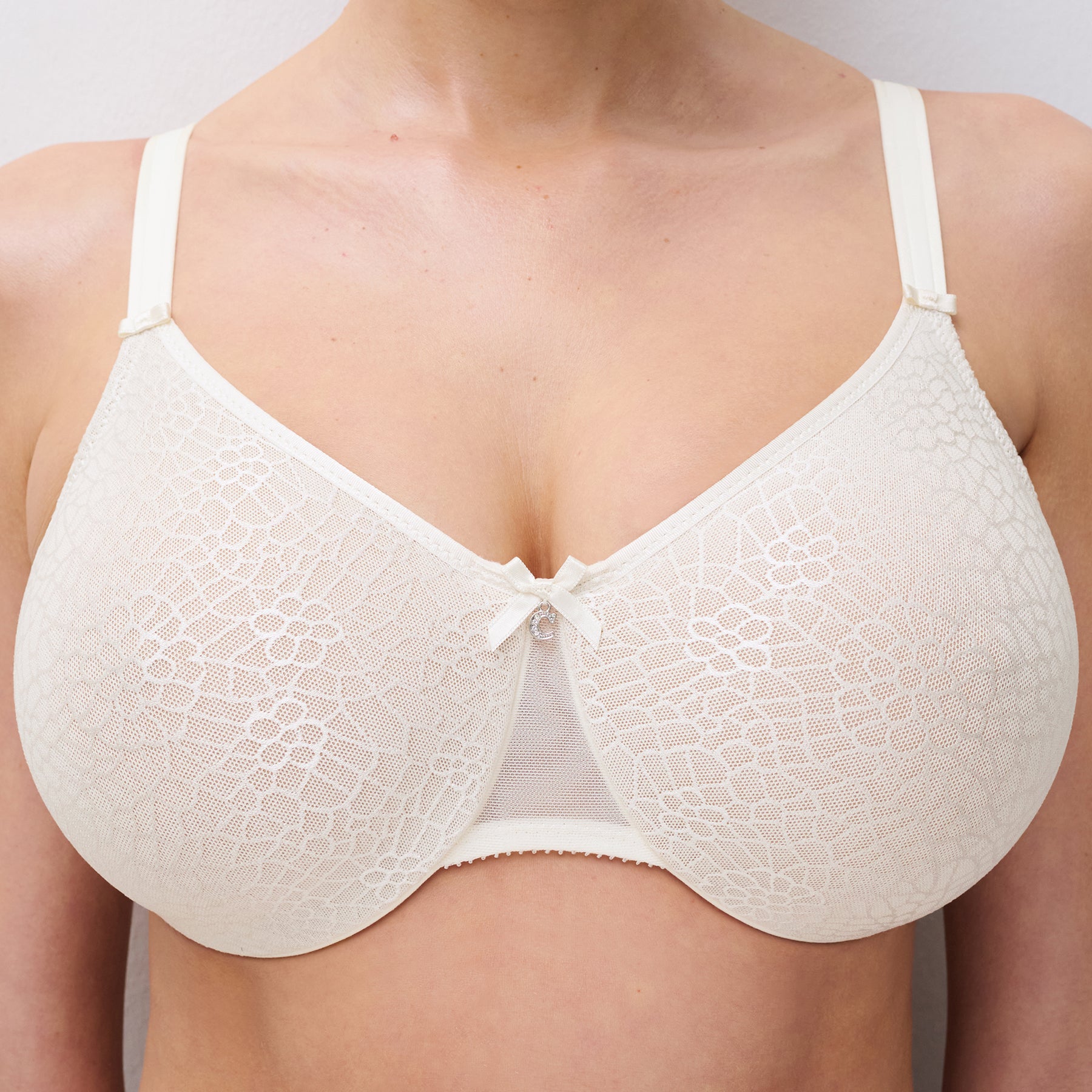 Chantelle C1891 C Magnifique seamless minimizing full cup bra in ivory 035. Front view close up on model.