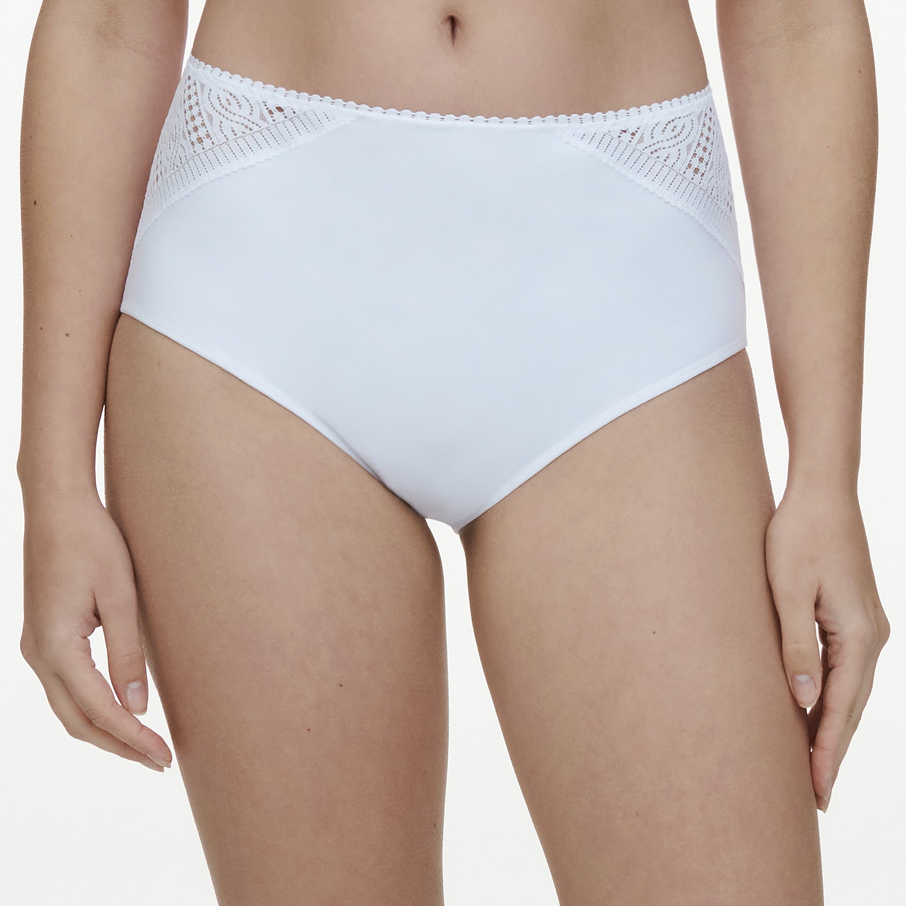 High waist full brief in white with knit front panels at hips. Front view close up on model.