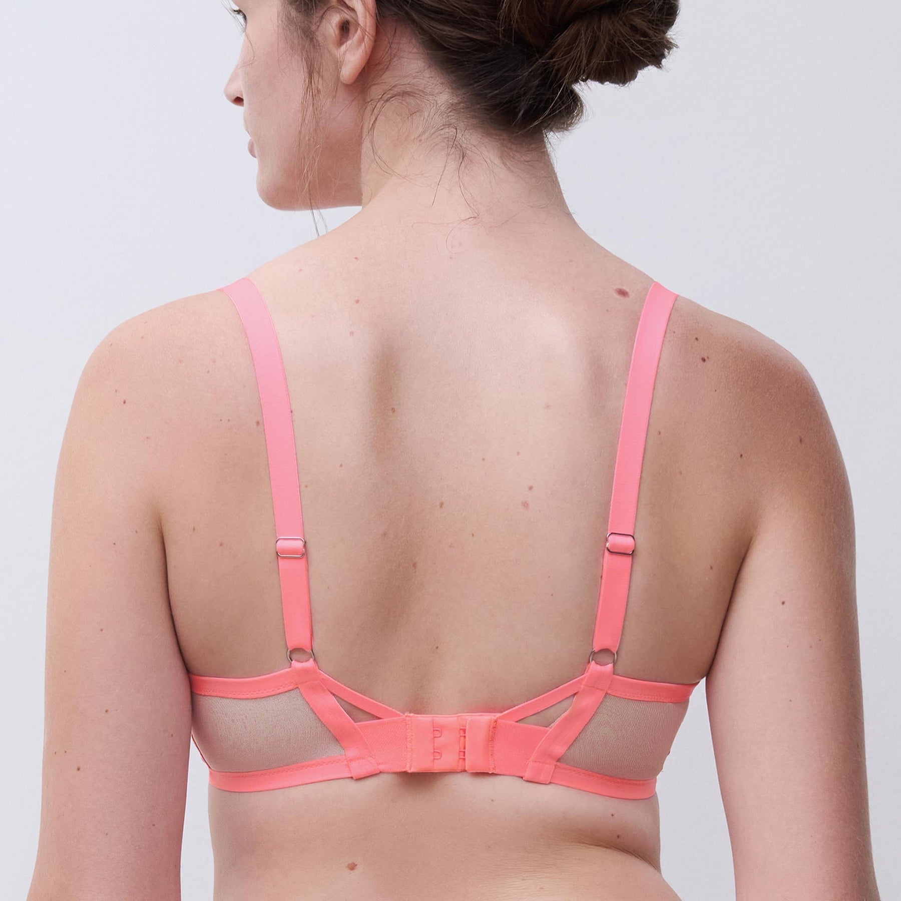 Full cup unlined bra in rose miami bubblegum pink in sheer tulle with daisy embroidery. Rear view closeup on model.