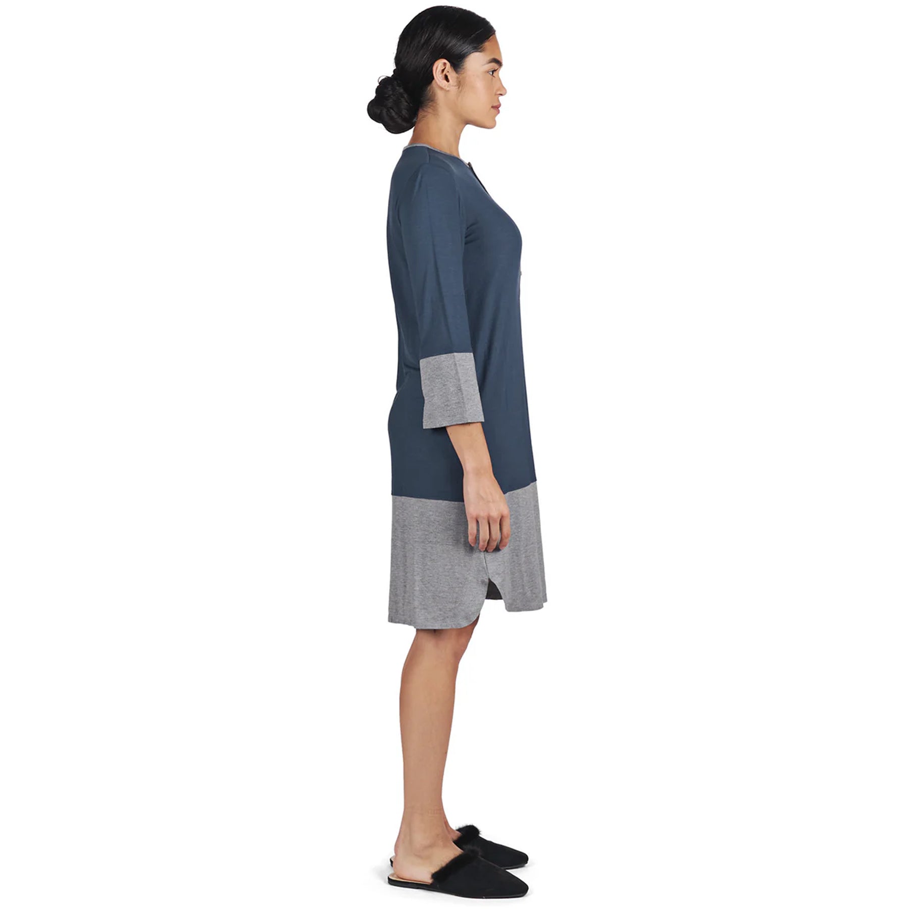 Side view of woman wearing two-tone midnight blue and grey nightshirt with relaxed fit and 3/4 sleeves.