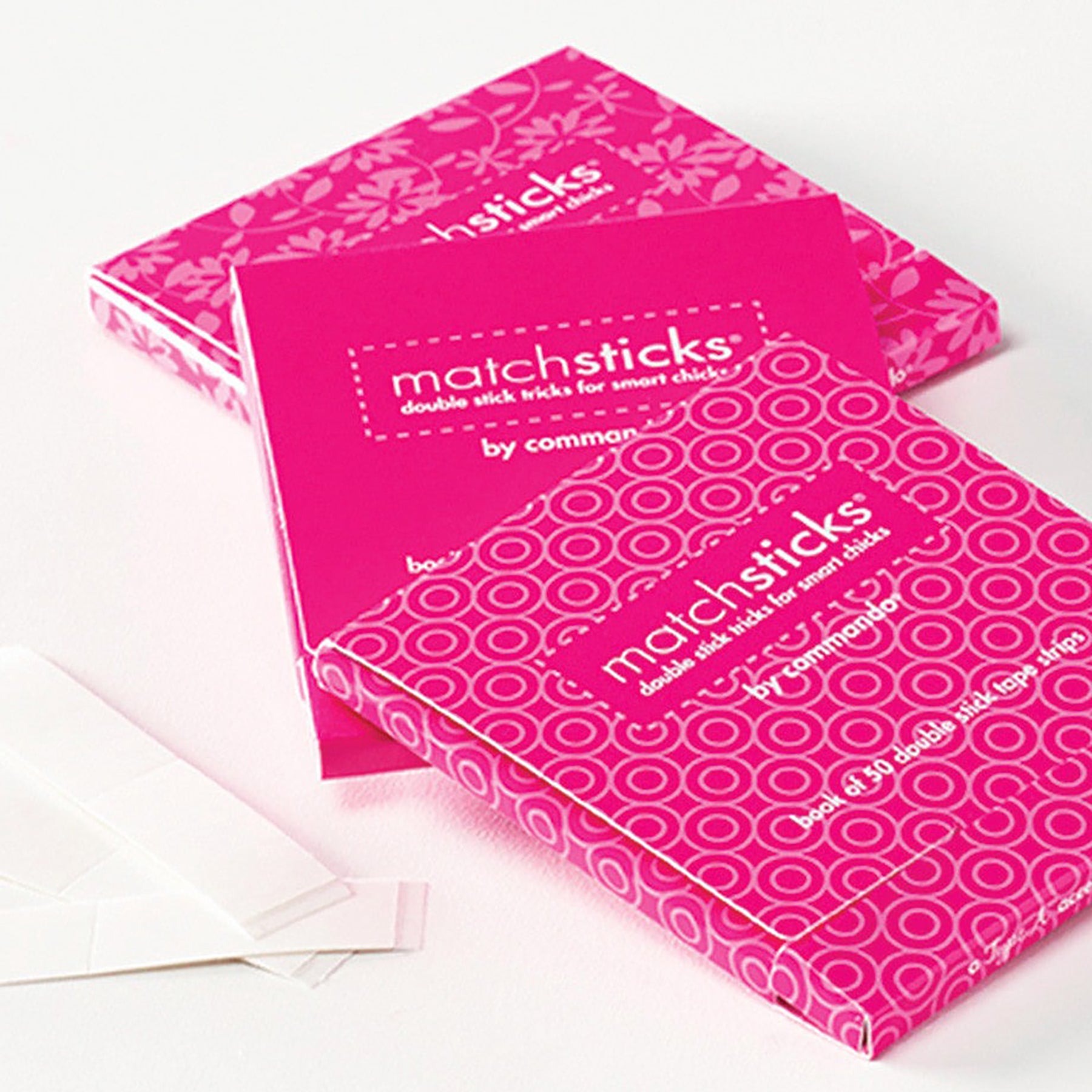 Commando Matchsticks double stick tape book shown open and stacked, displaying pink patterned covers and compact design