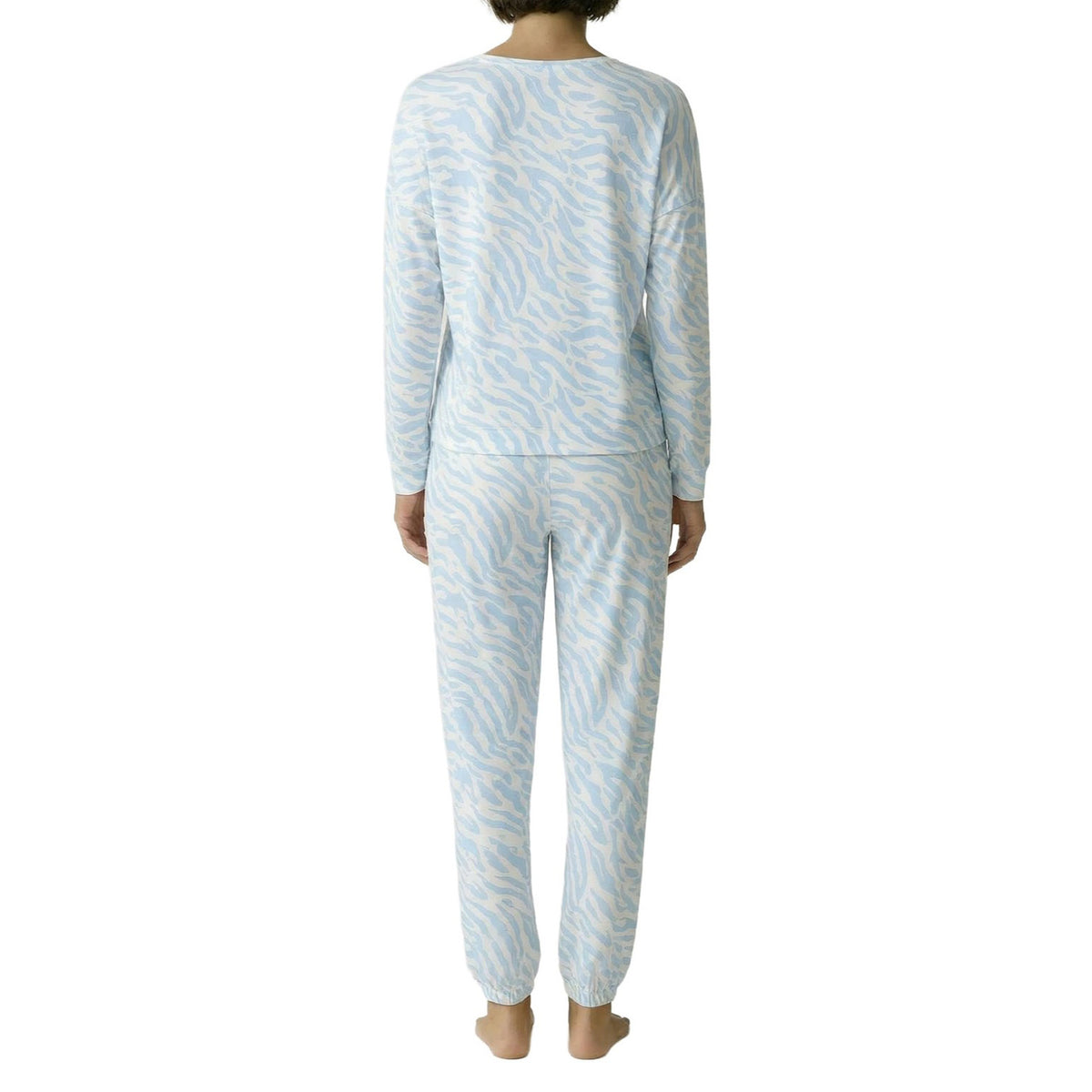 Model wearing a light blue and white zebra print pyjama set with long sleeves and jogger-style pants, back view.