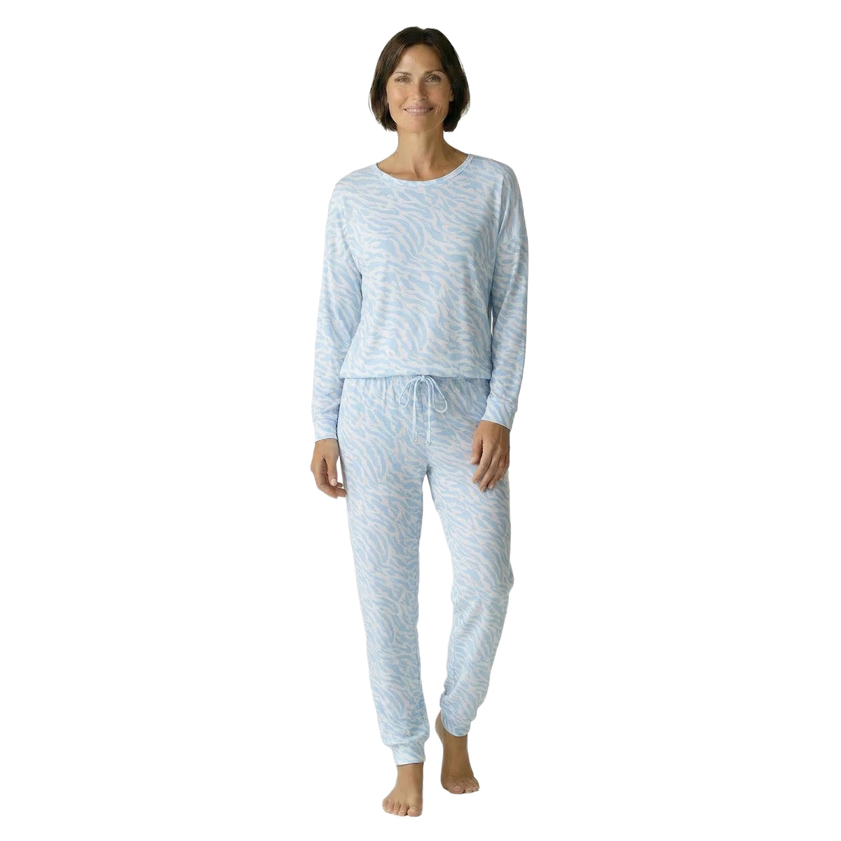 Model wearing a blue zebra print pyjama set with a relaxed long-sleeve top and matching drawstring jogger pants, front view.
