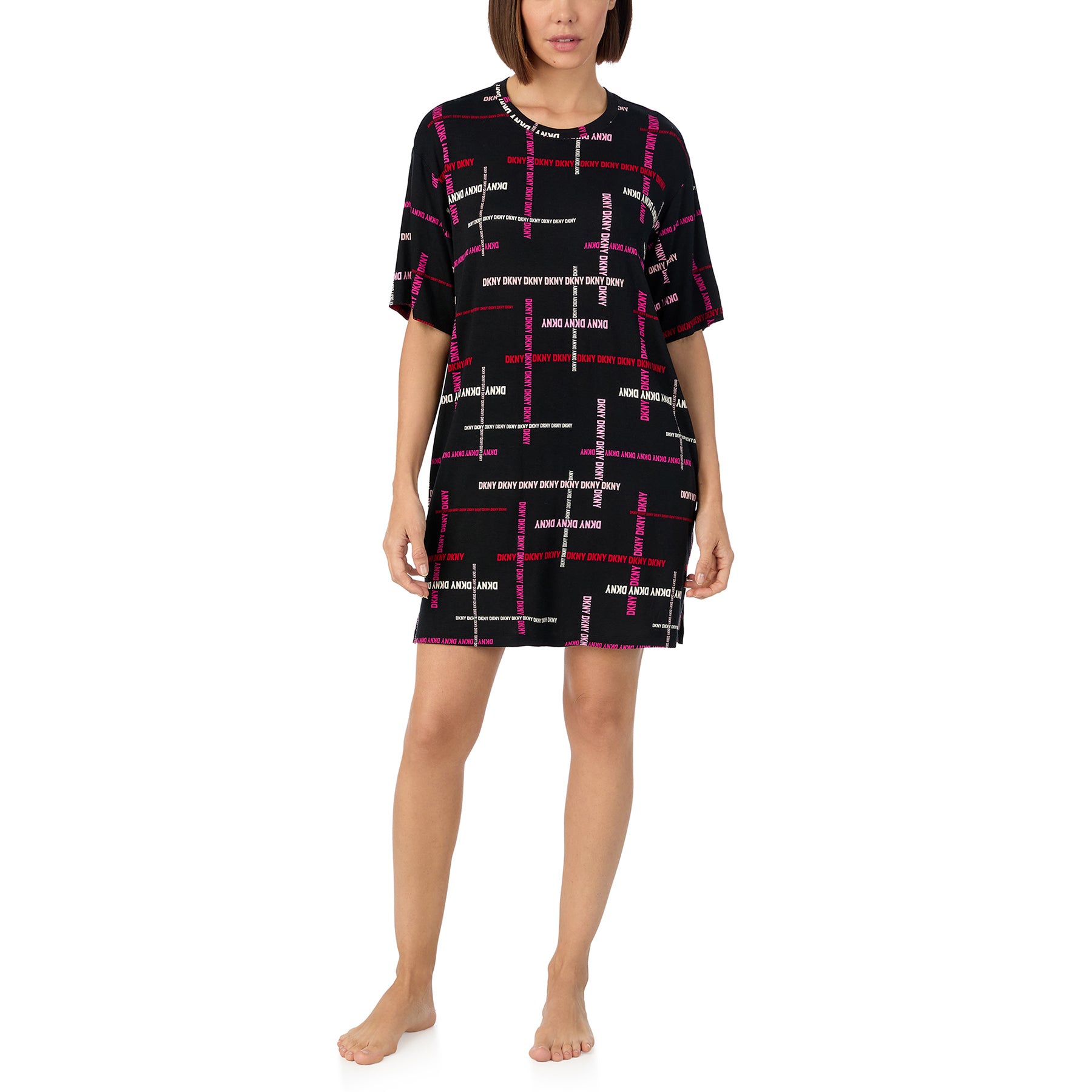 Short sleeve round neck sleepshirt in black with DKNY logo print in shades of pink. Front view on model.