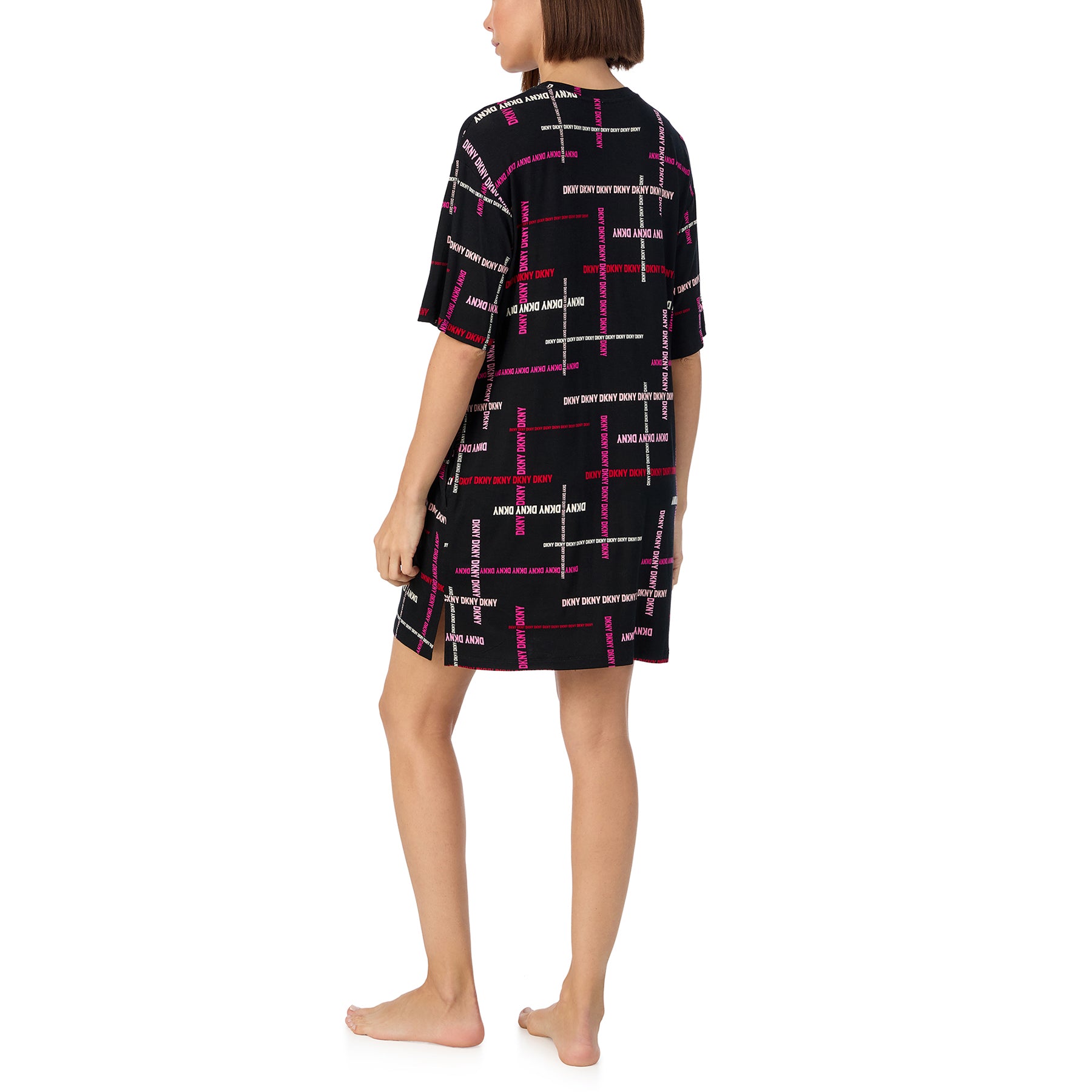 Short sleeve round neck sleepshirt in black with DKNY logo print in shades of pink. Rear view on model.