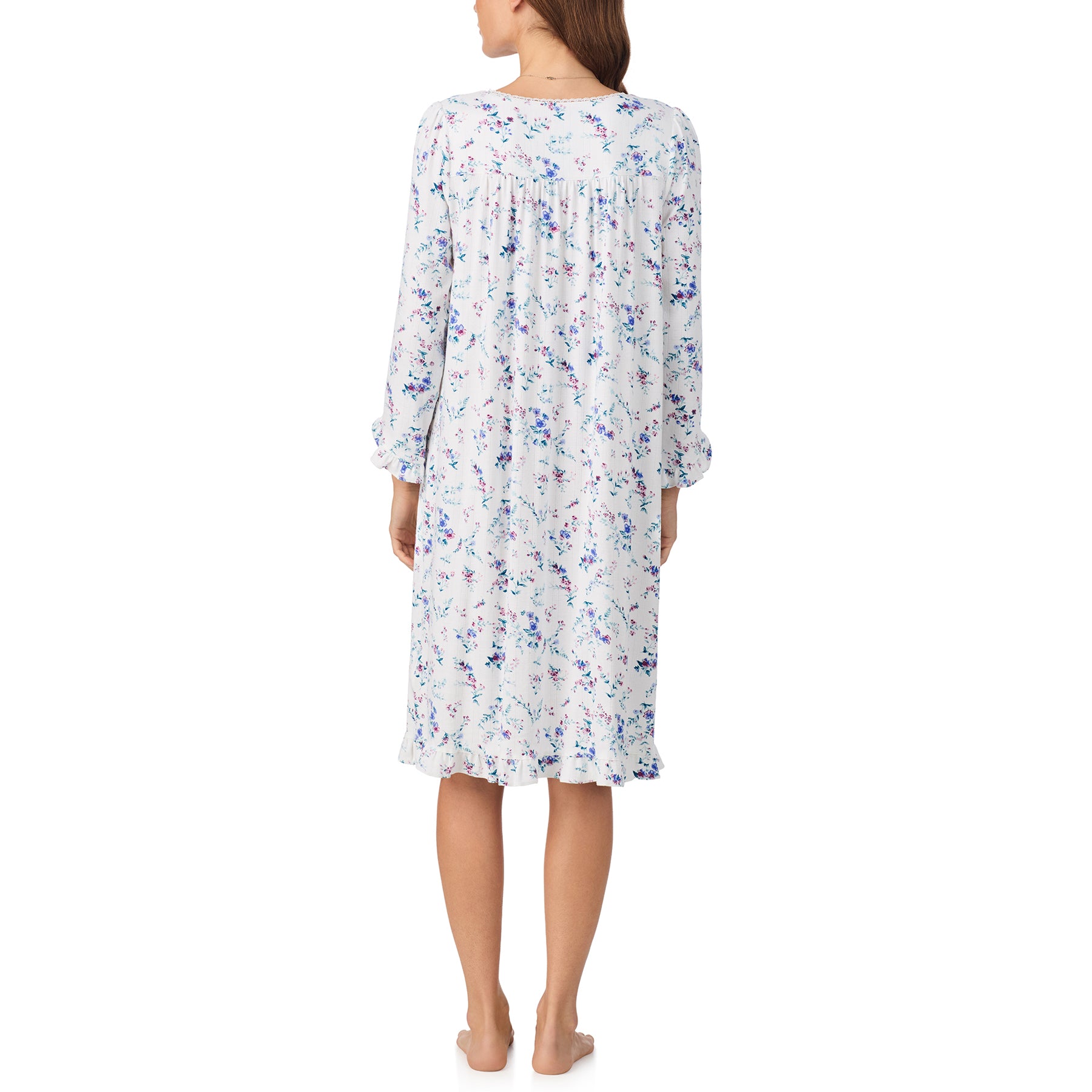 Woman wearing a floral nightgown on a white background