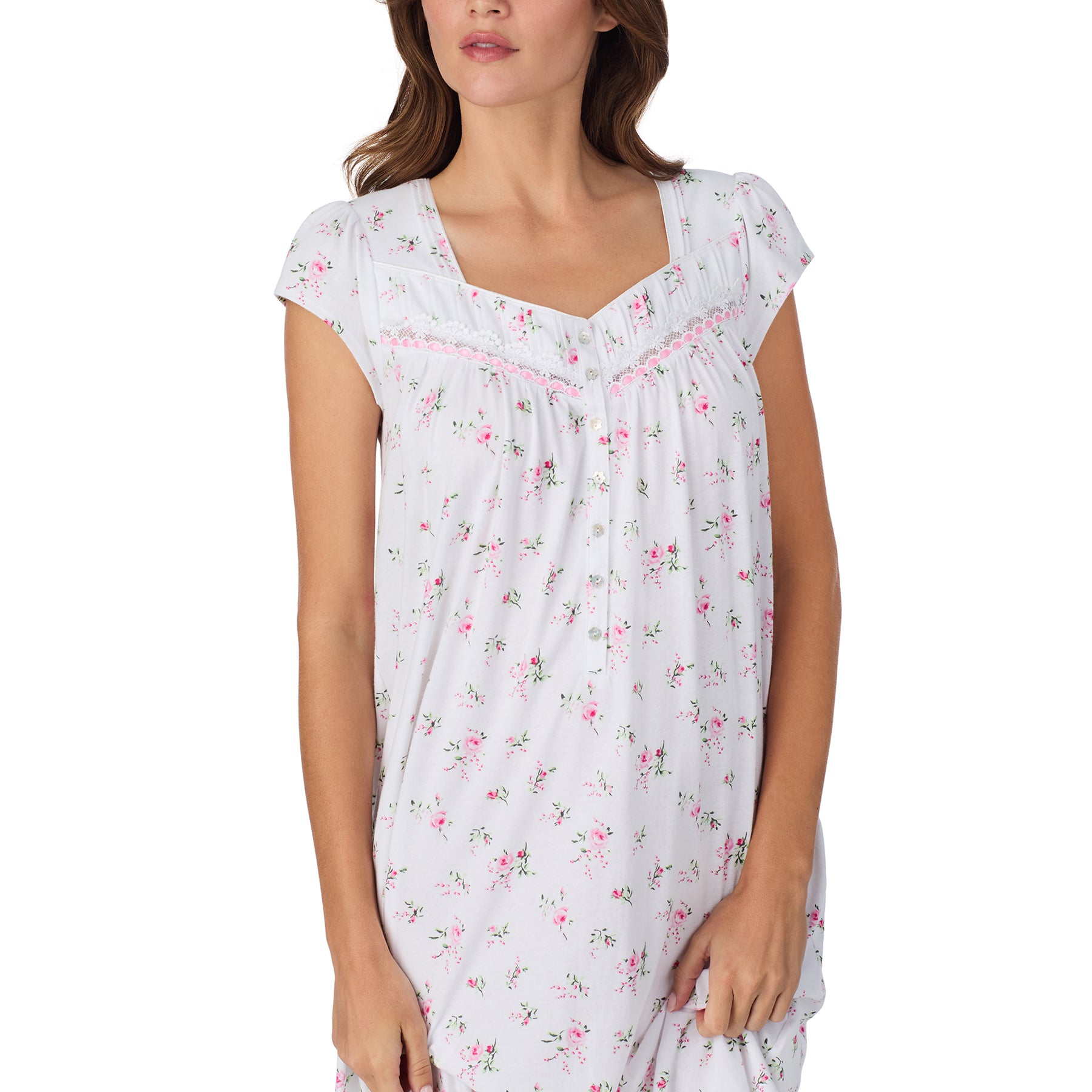 Close-up of a white floral nightgown featuring a lace-trimmed square neckline, button-front detail, and soft pink rose print.