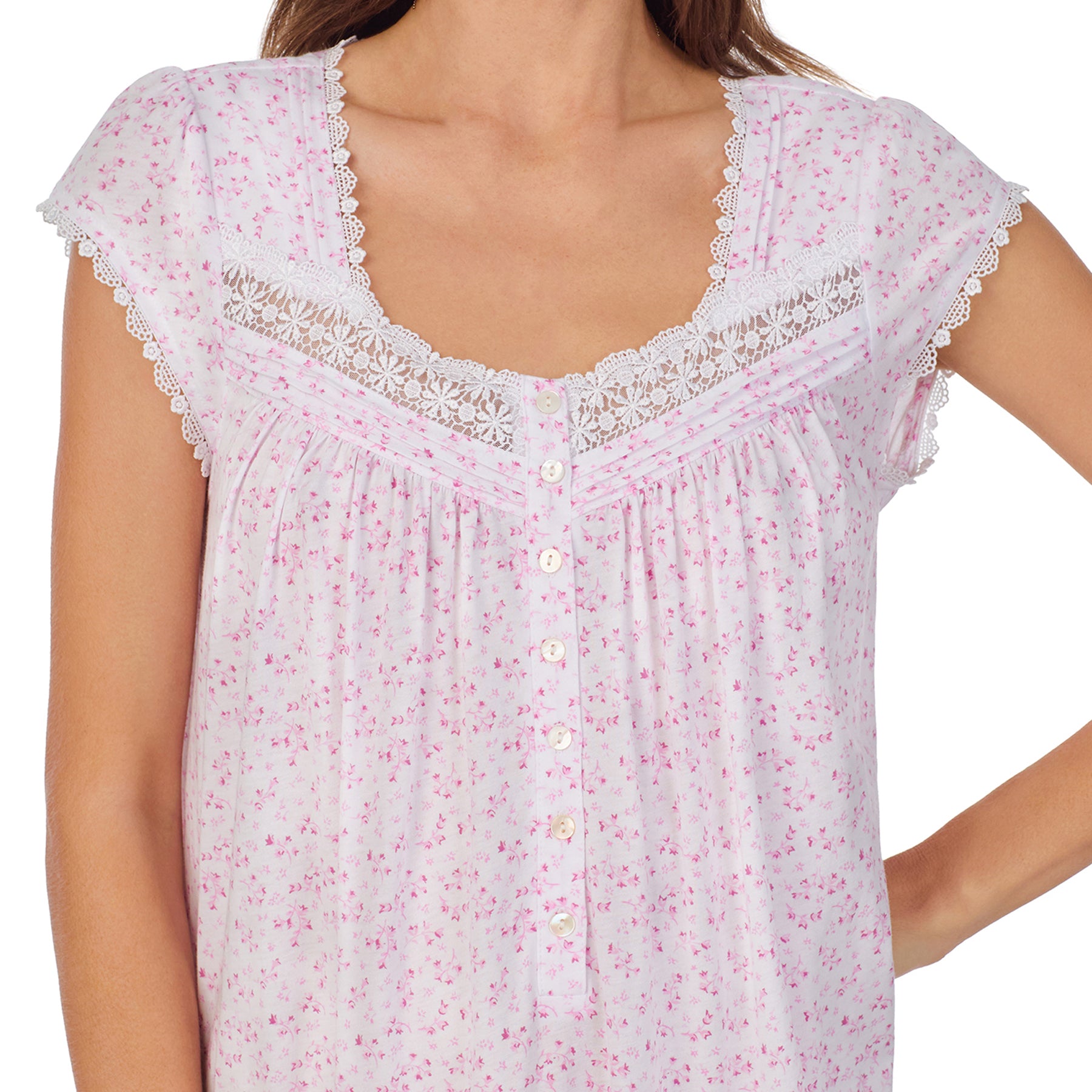 Close-up view of a women's floral nightshirt in a white pink ditsy print, showcasing intricate lace trim, button detailing, and cap sleeves.