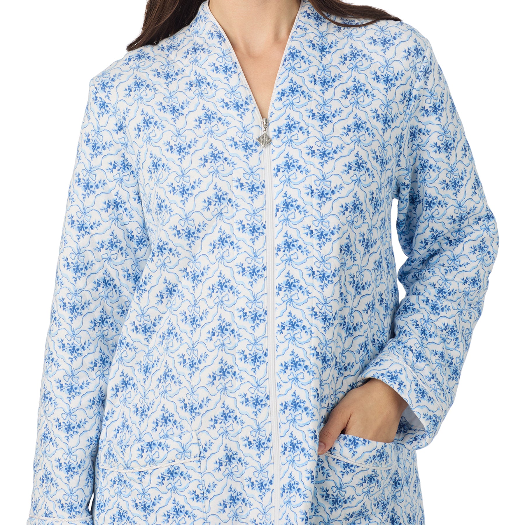 Close-up of blue and white floral zip-front robe with pockets and long sleeves by Eileen West.