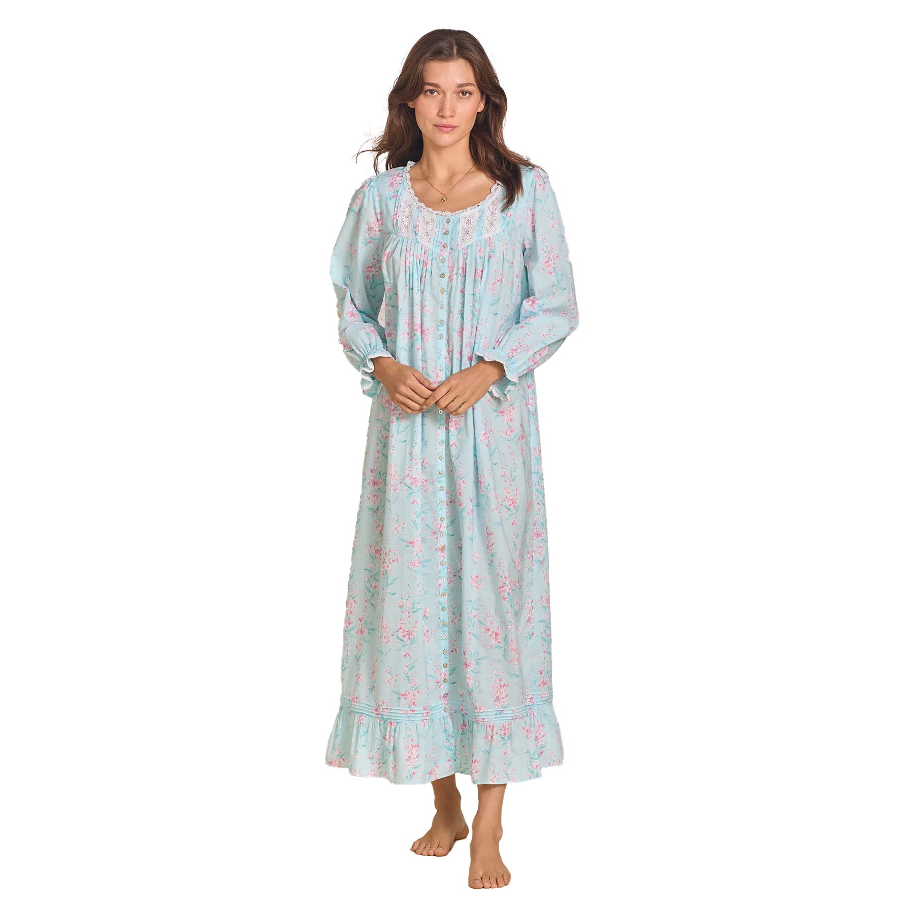 The model standing with hands clasped, showcasing the delicate floral pattern, lace detailing, and elegant drape of the nightgown.