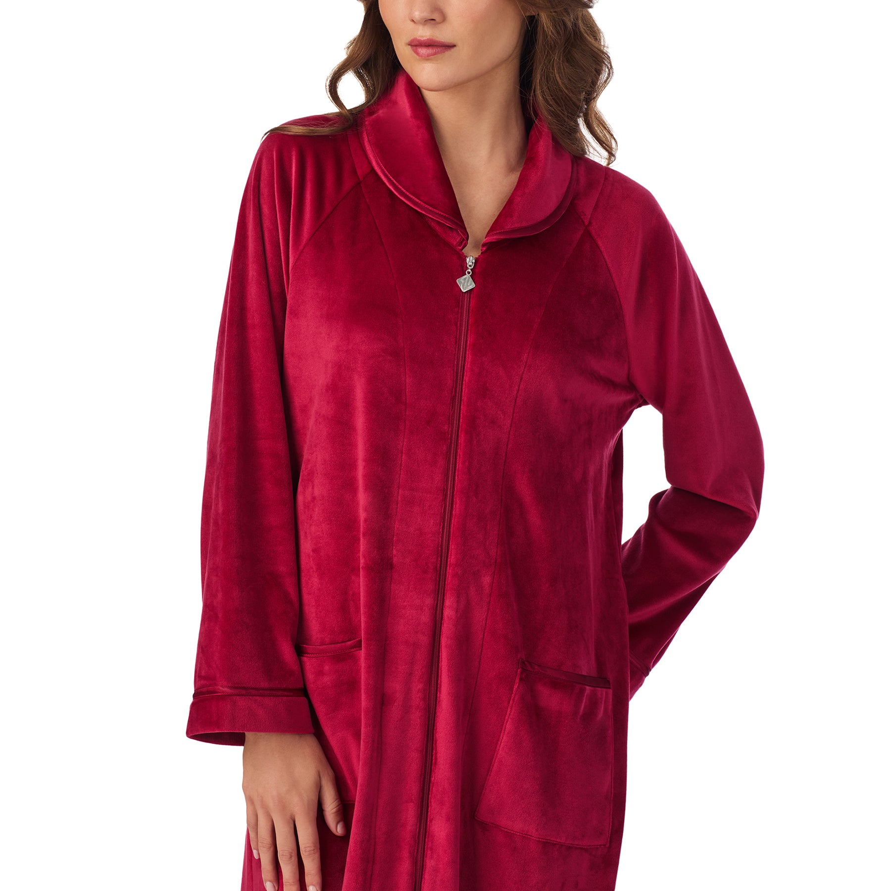 Close-up of wine red velour robe showing collar, zipper, and pocket details.