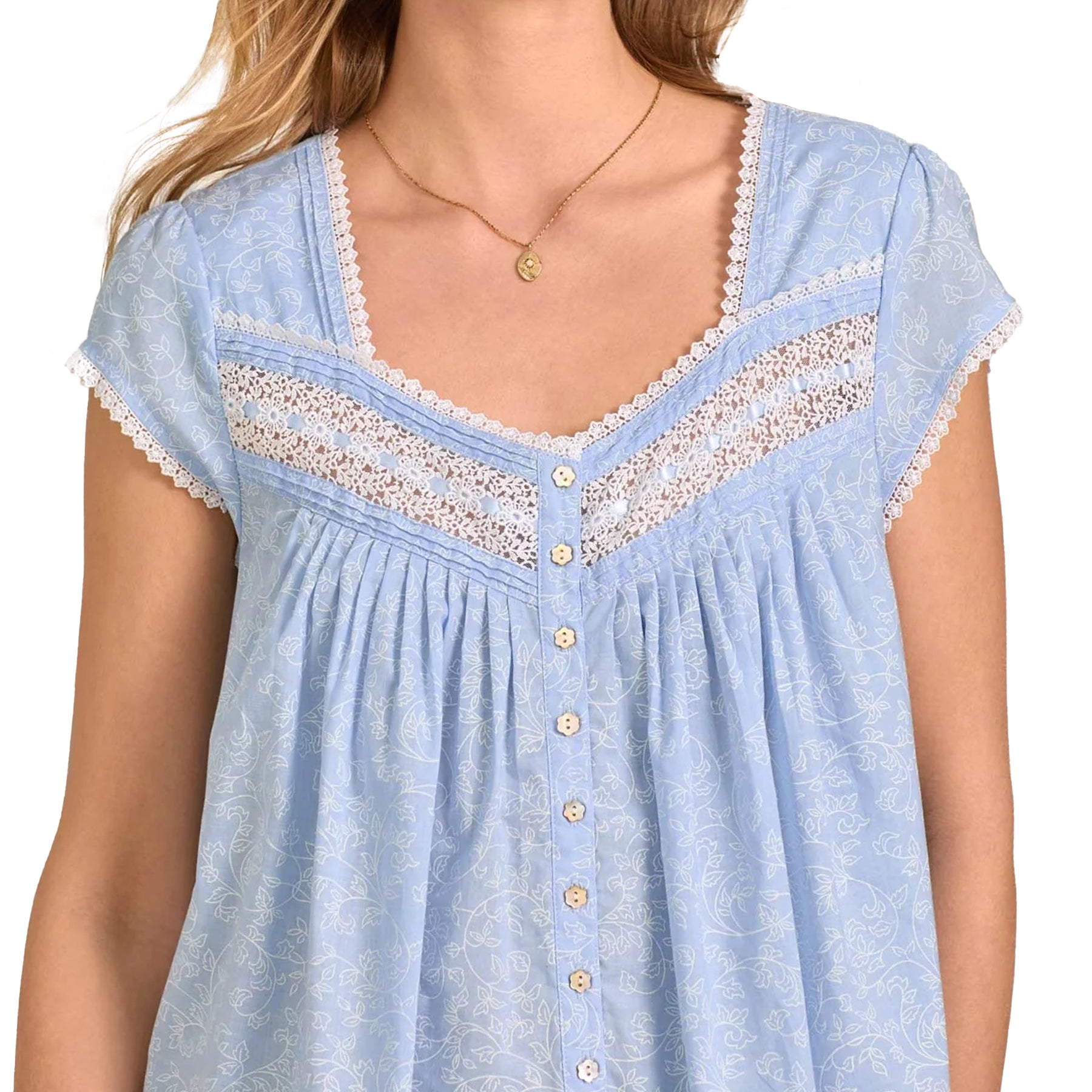 Close-up of lace-trim neckline and button placket on light blue printed cotton nightgown