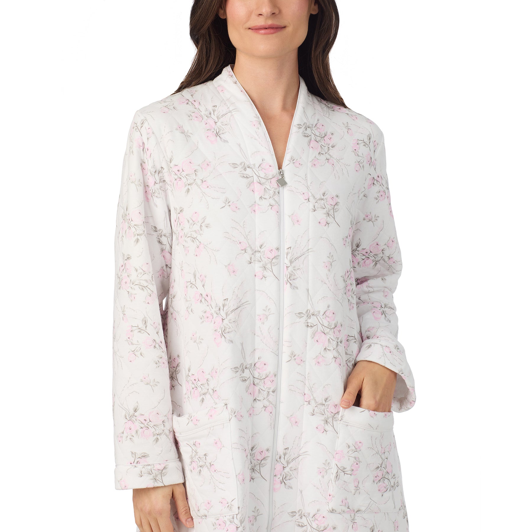 Woman wearing Eileen West white quilted robe with pink rose print, hands in pockets, front view