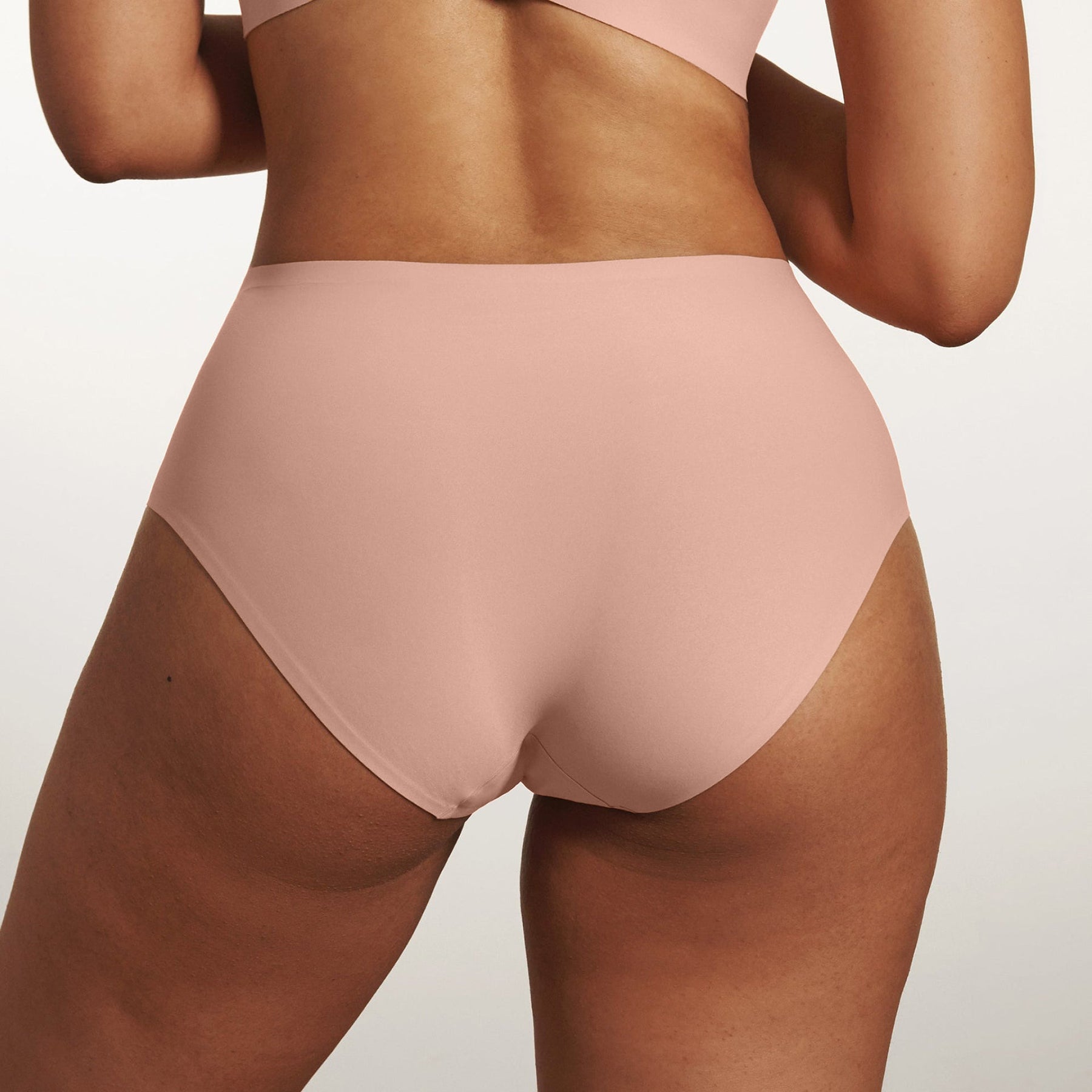 Back view of Evelyn & Bobbie Himalayan Salt high waist seamless full coverage underwear on curvy model