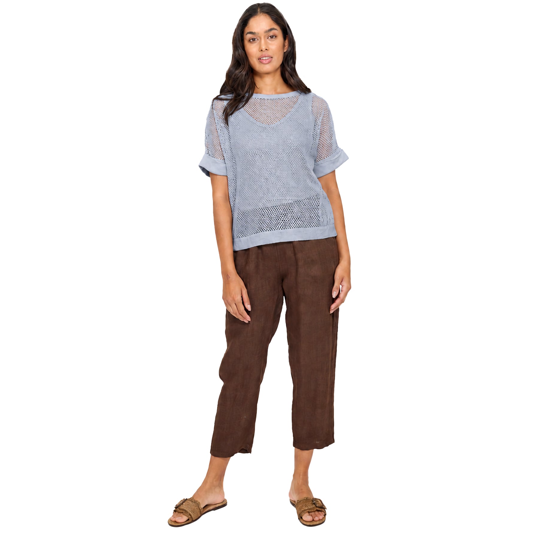 Light blue mesh short sleeve top on a model, featuring a relaxed fit with sheer open-knit texture and rolled sleeve cuffs for a modern layered look.