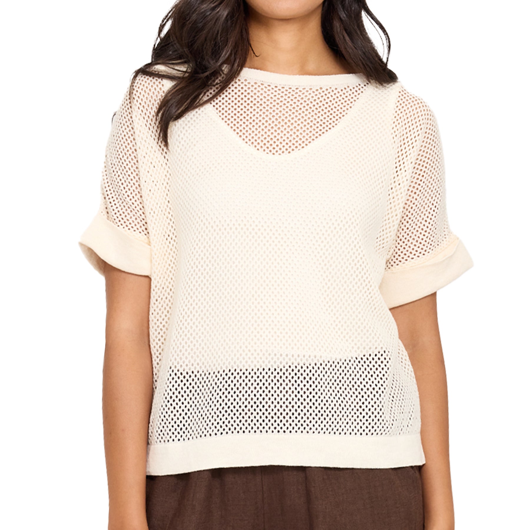 Woman wearing a beige mesh top on a white background