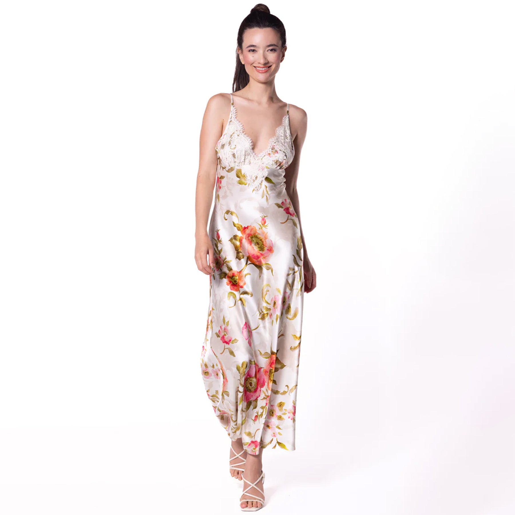 Front view of a woman wearing a floor-length floral satin nightgown with lace-trimmed neckline and thin adjustable straps.
