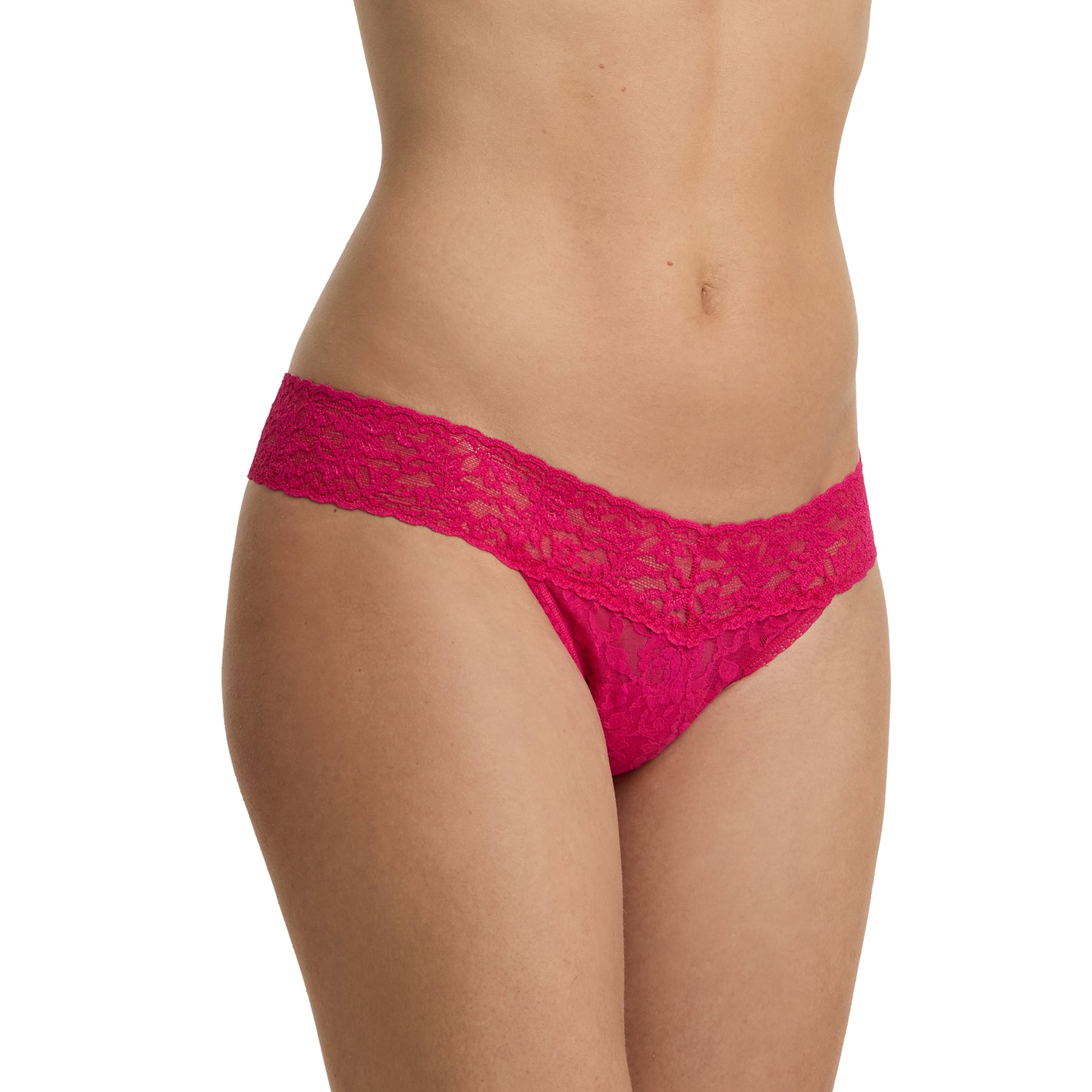 Side view of model wearing bright fuchsia lace low rise thong with soft stretch lace and scalloped waistband
