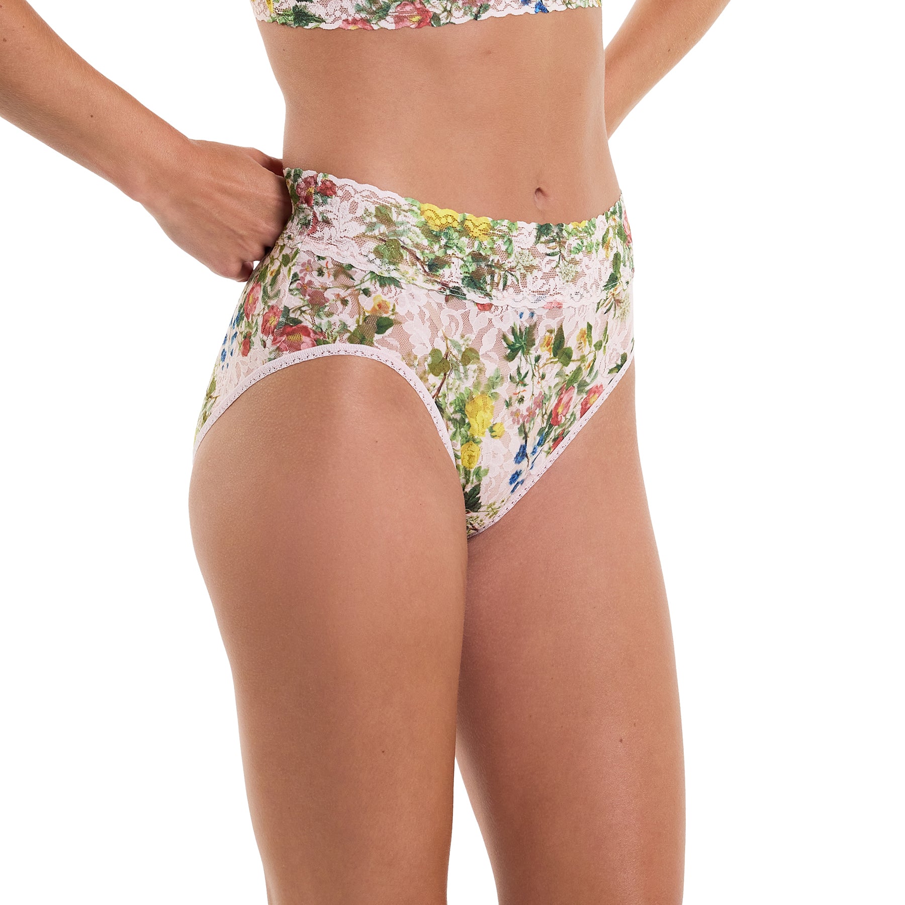 Printed lace high waist french cut full brief in pink, green and blue florals on a light pink background, side view on model.