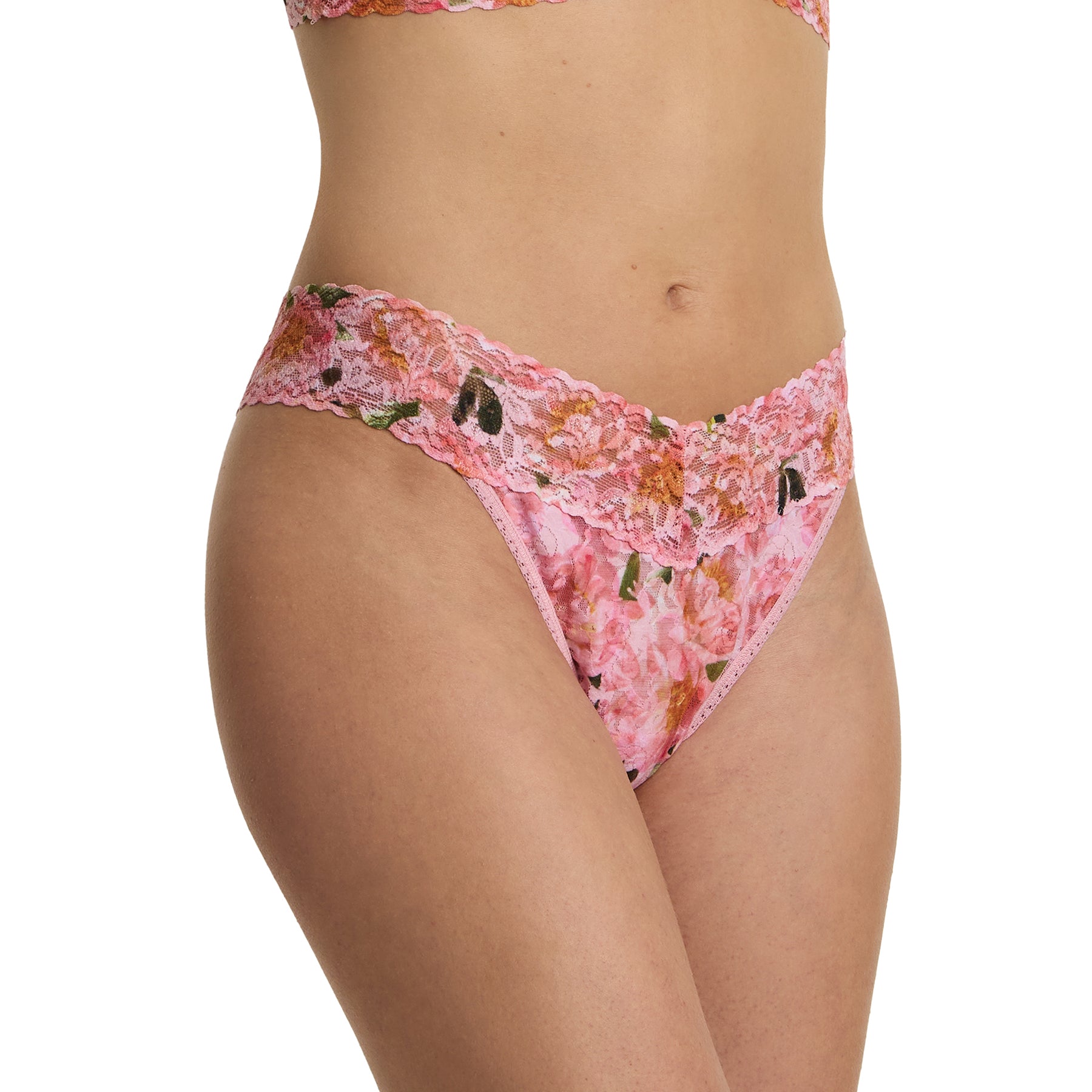 Model wearing pink floral lace original rise thong in the Dancing Petals print with soft stretch lace and scalloped waistband front angle