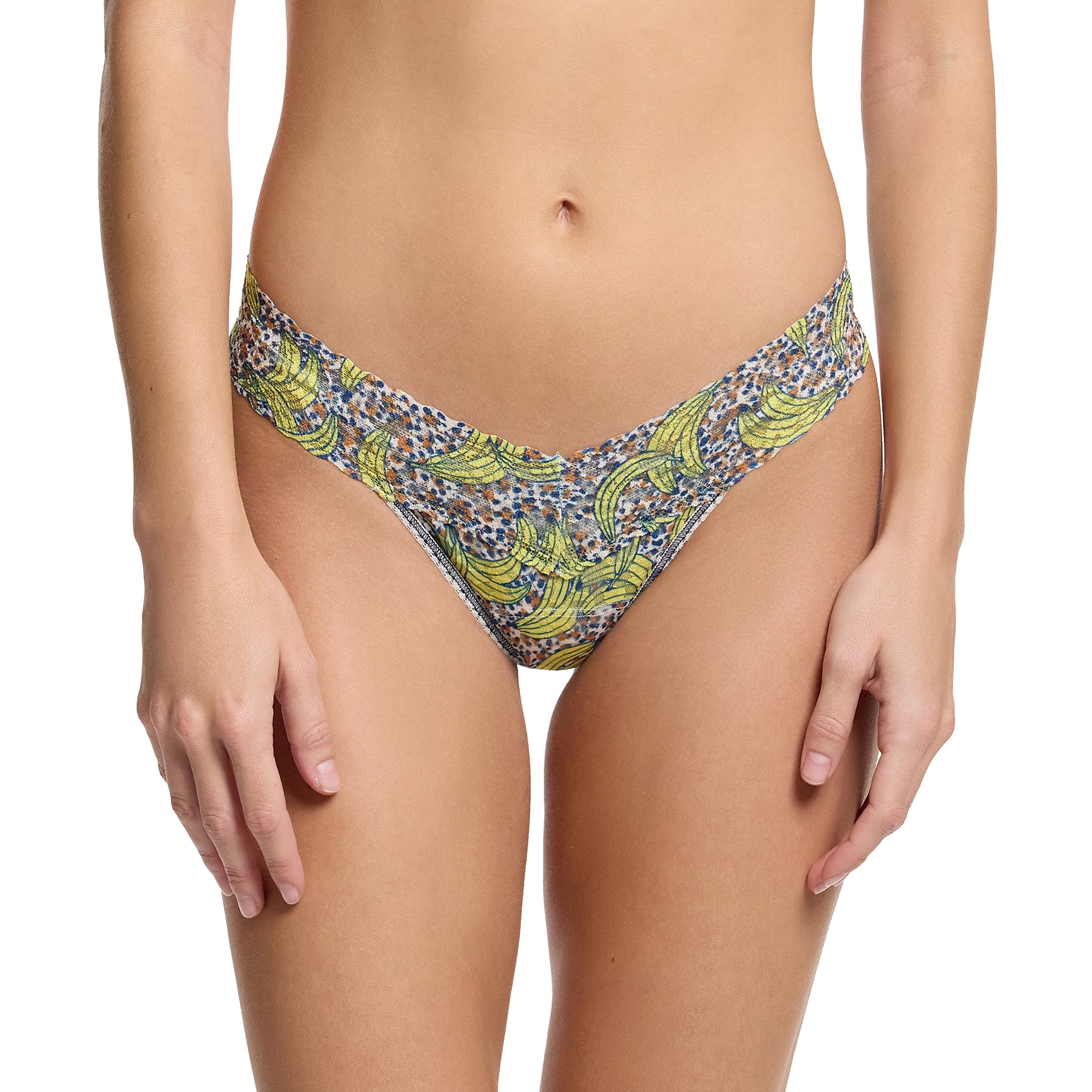 Hanky panky printed lace low rise thong in pick me, yellow banana print on a brown and navy dot print background. Front view on model.