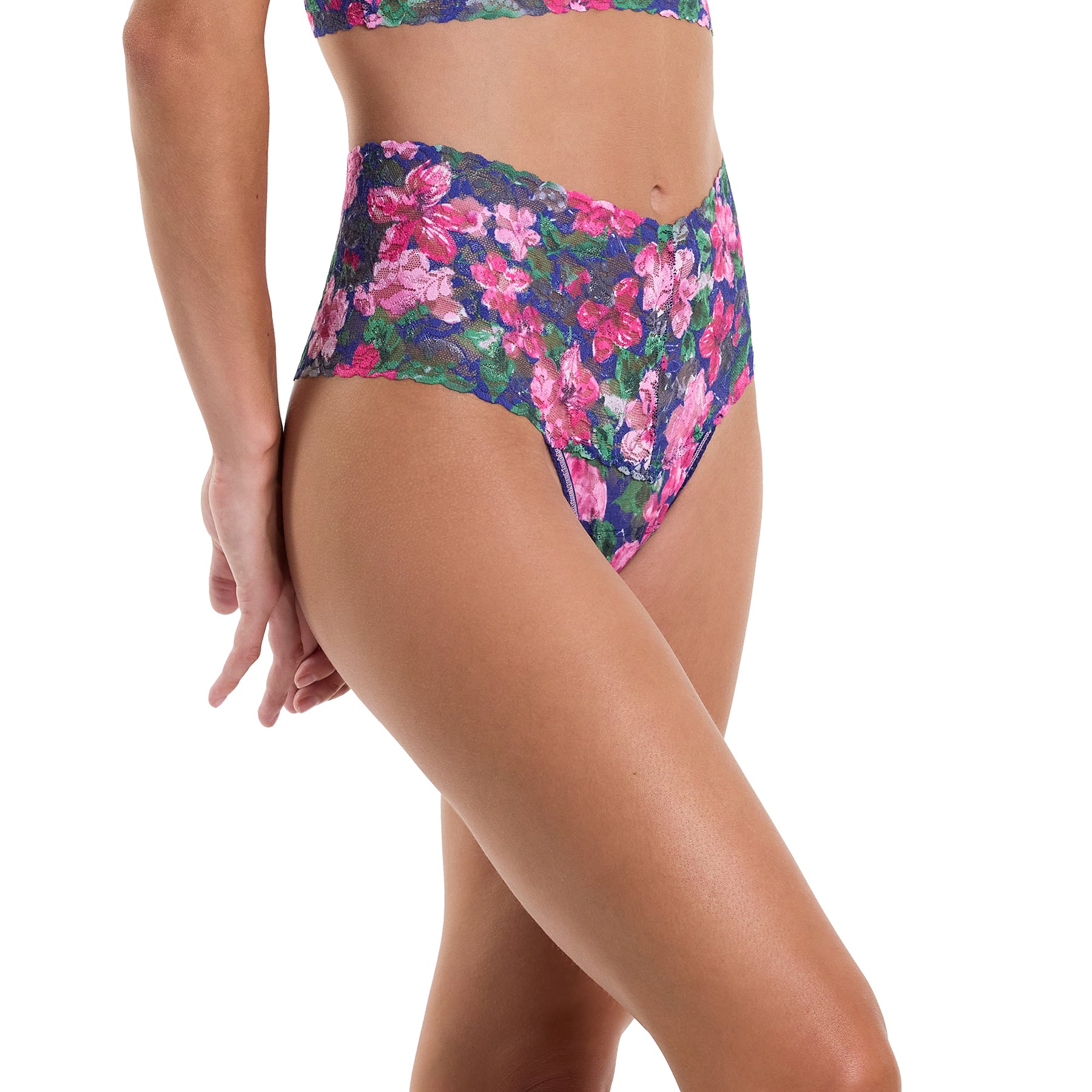 Wide band printed lace high rise thong with pink and green florals on a navy background. Side view on model.