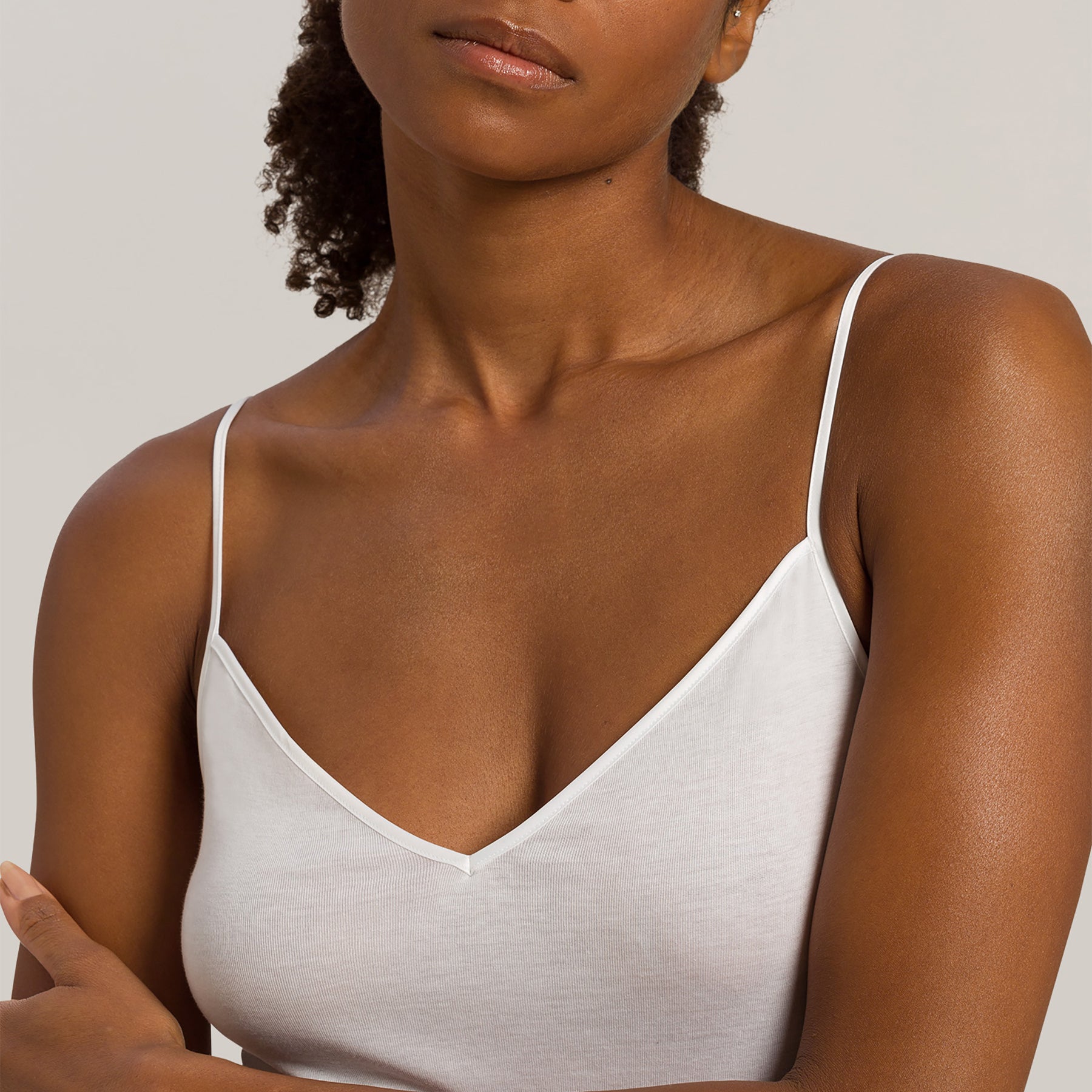hanro cotton seamless v-neck spaghetti strap tank white 101 front view close up on model