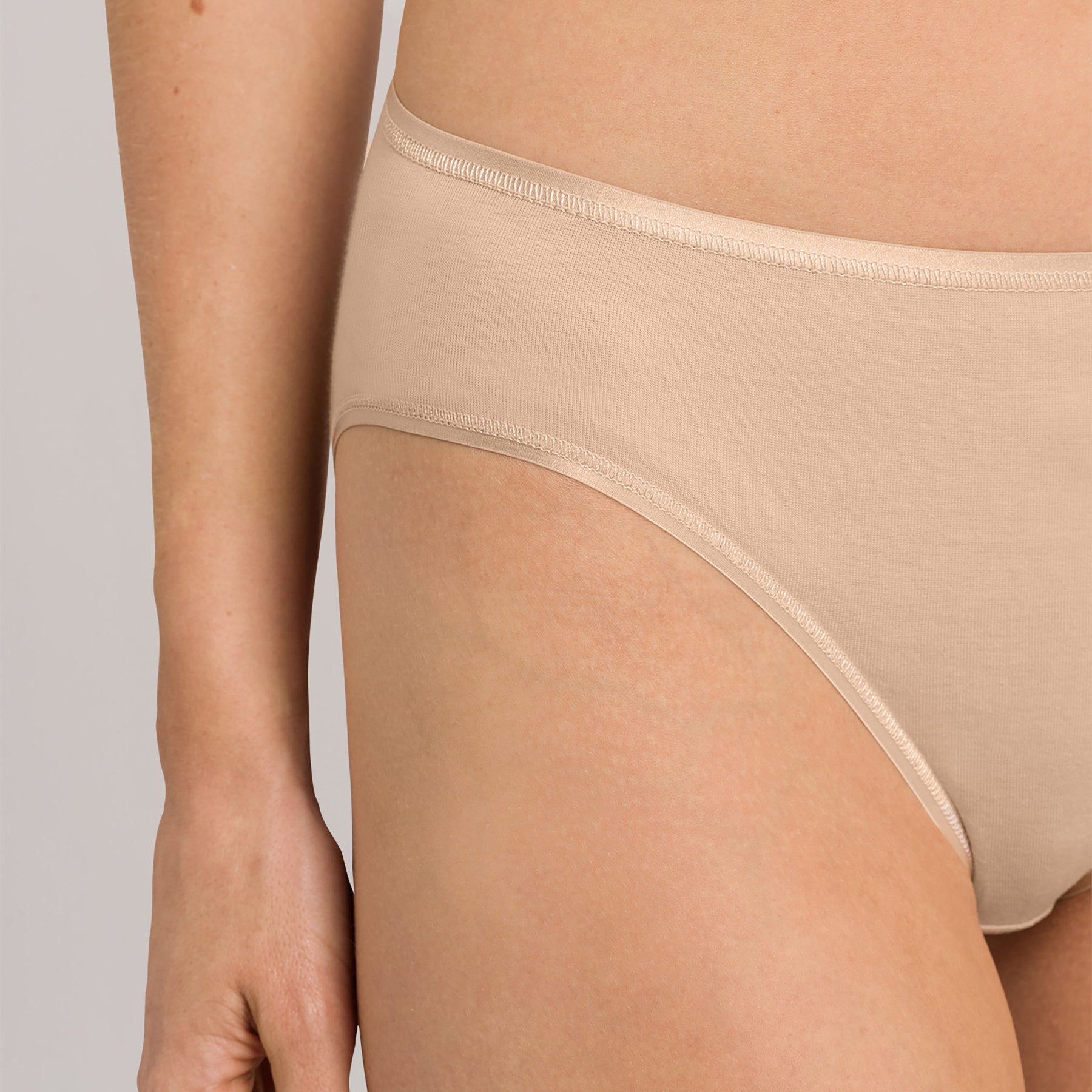 Close-up of Hanro Cotton Seamless Bikini Panty in Beige featuring soft, breathable cotton and smooth edges.