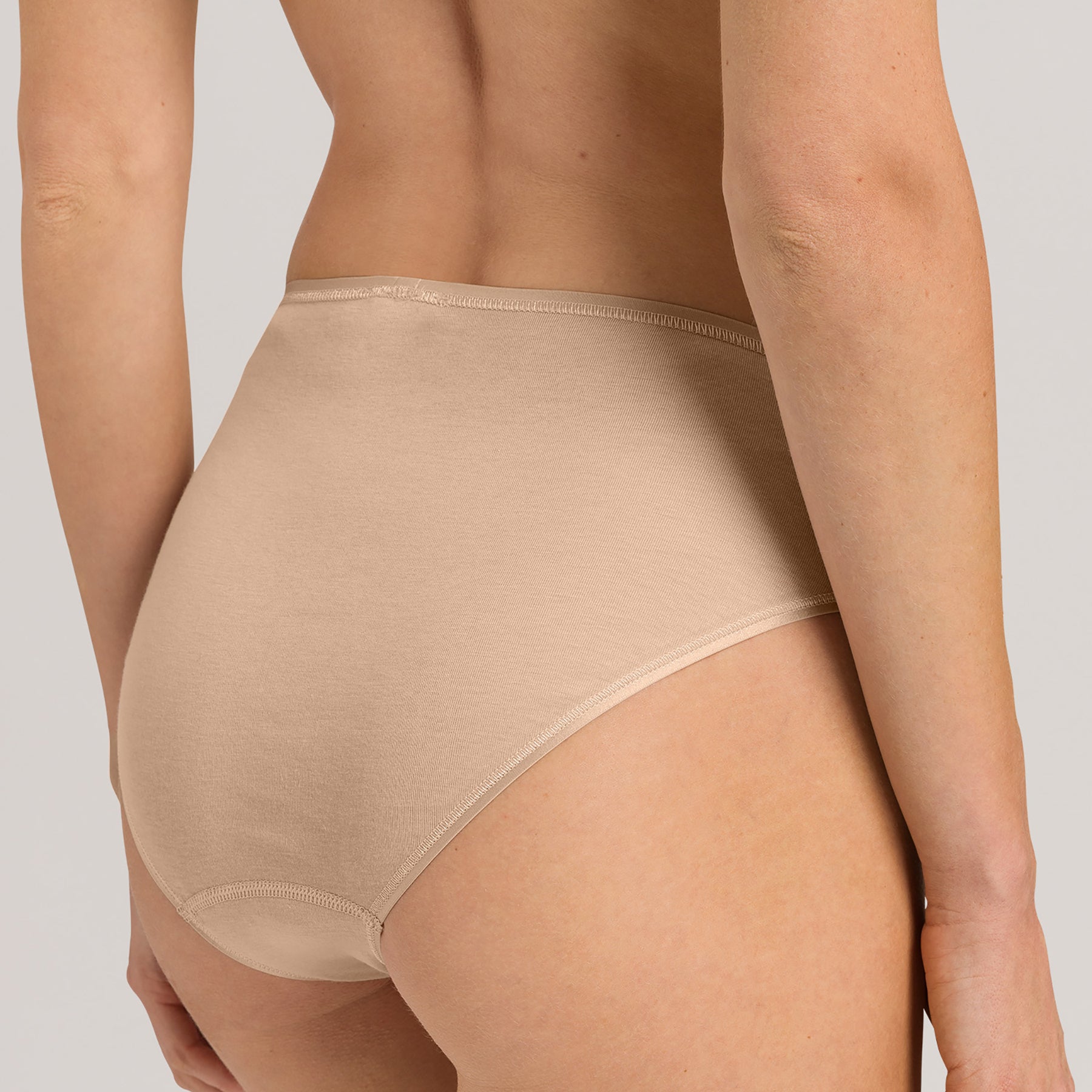 Back view of Hanro Cotton Seamless Bikini Panty in Beige designed for comfort and invisible wear under clothing.