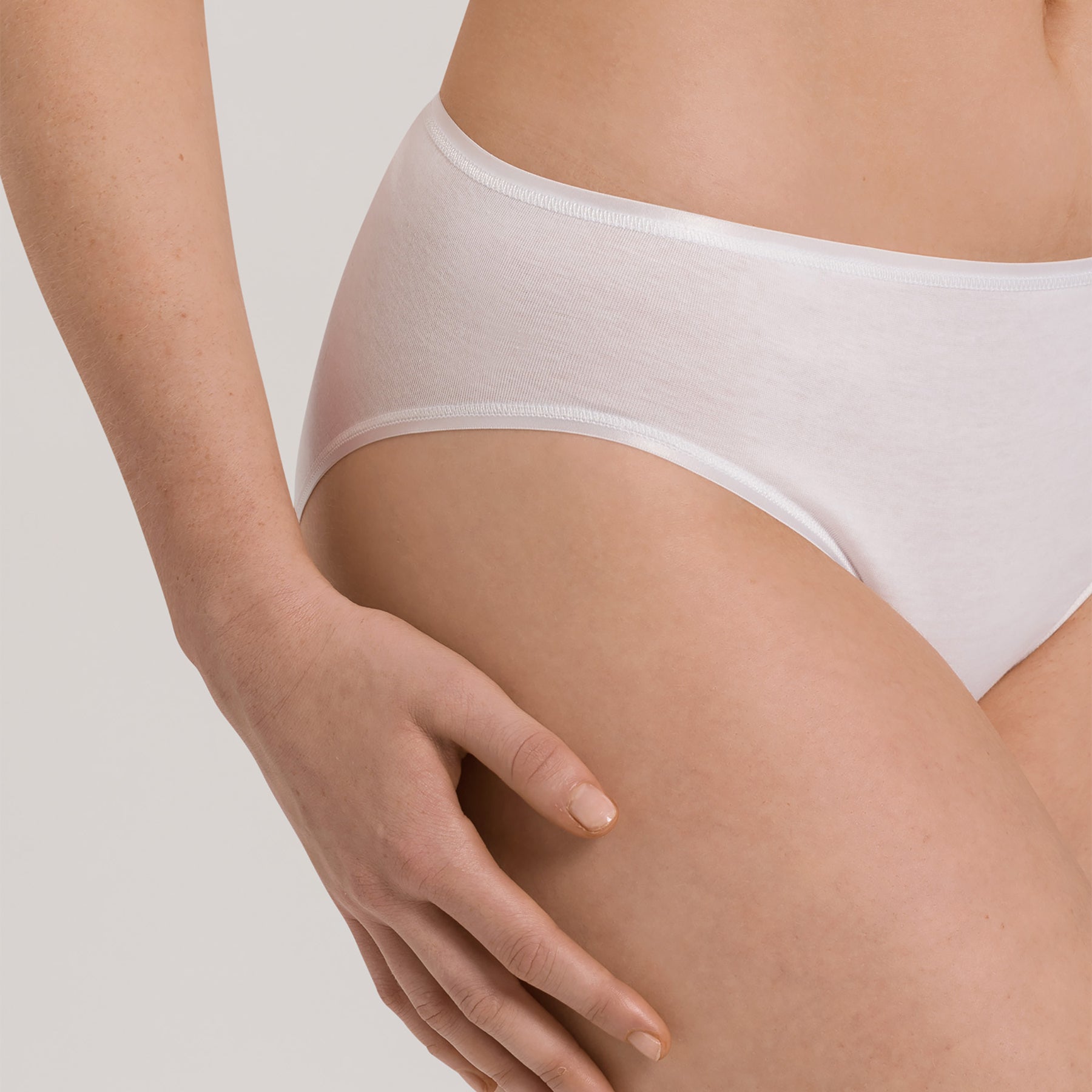 Close-up of Hanro Cotton Seamless Bikini Panty in White showing soft waistband and fine cotton rib texture.
