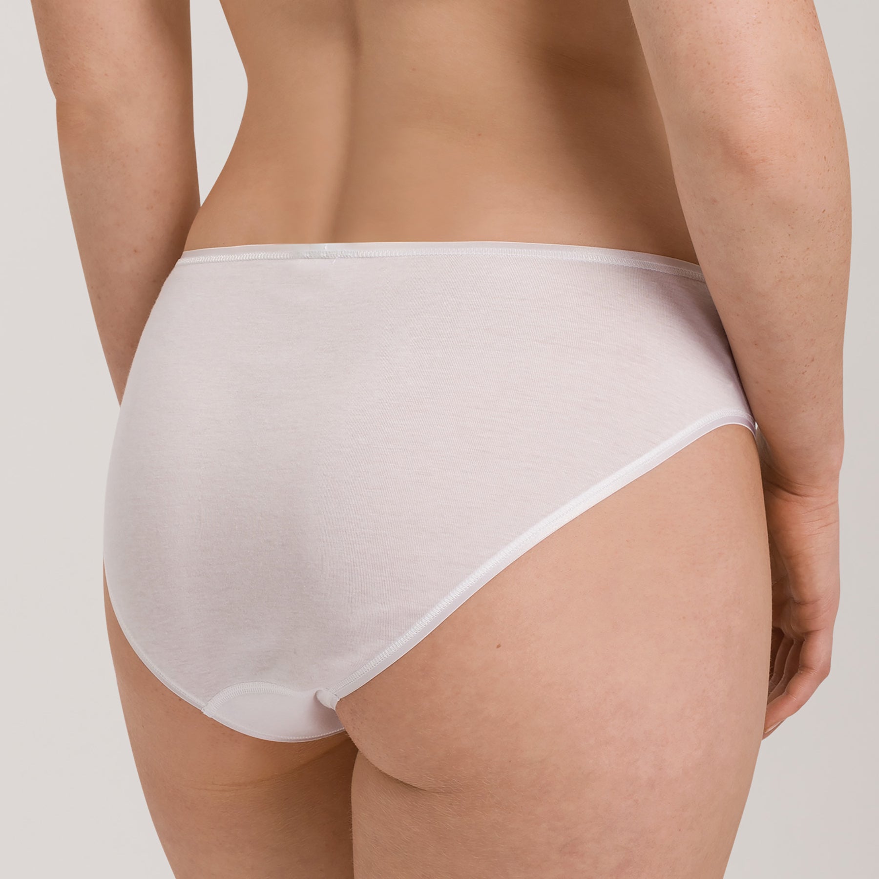Back view of Hanro Cotton Seamless Bikini Panty in White offering smooth coverage and invisible lines.