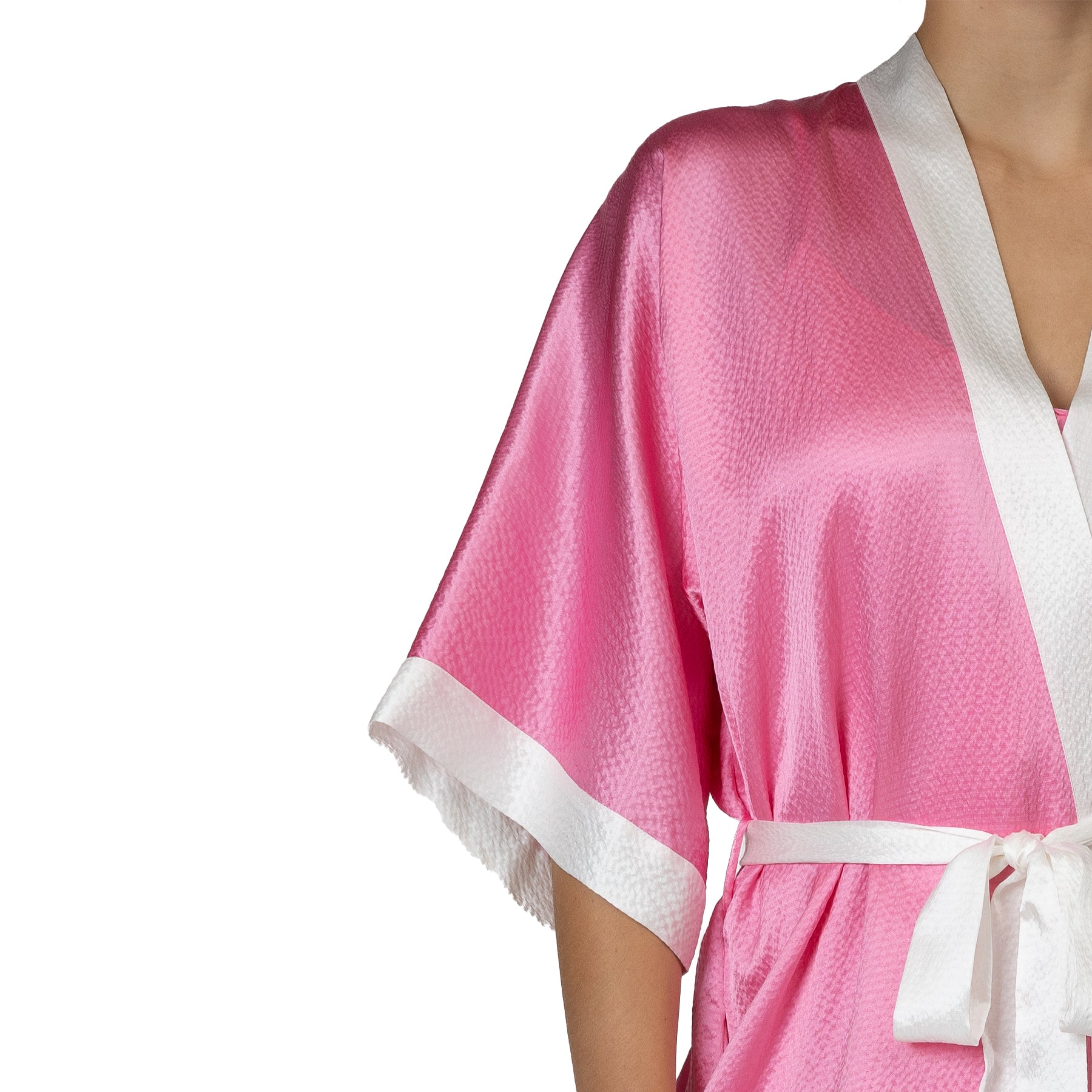 Close-up of pink hammered silk robe sleeve with textured finish and ivory cuff