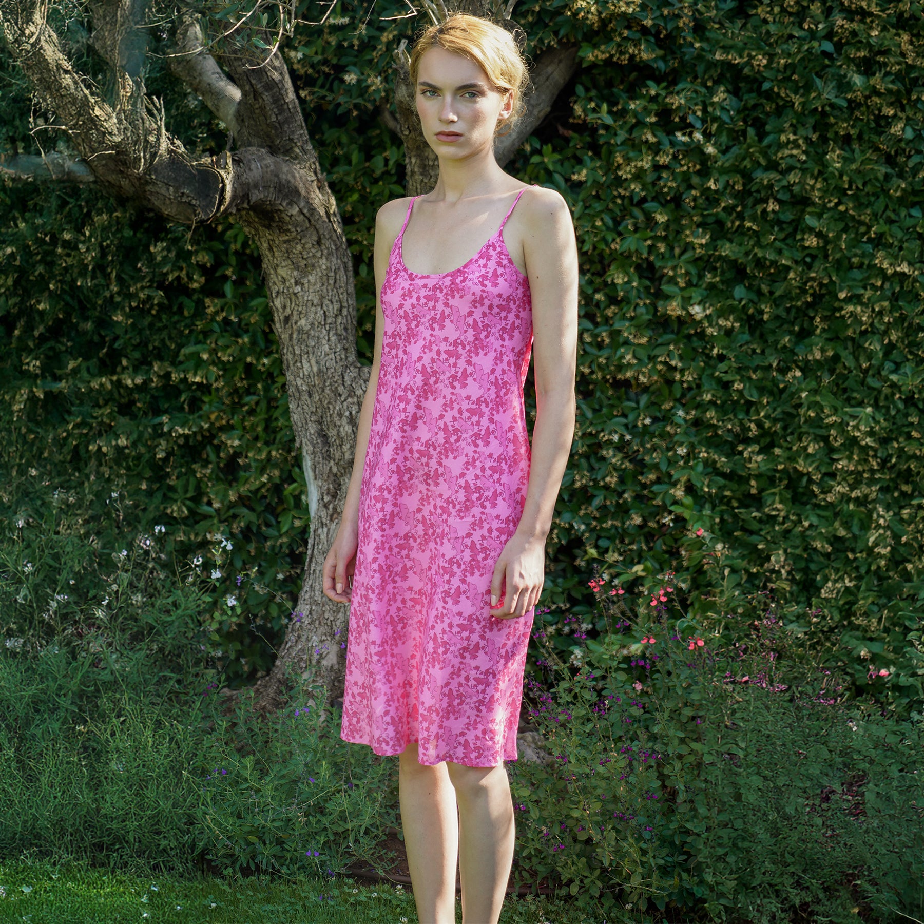 Chocho rose hot pink printed cotton spaghetti strap chemise. Front/side view on model.