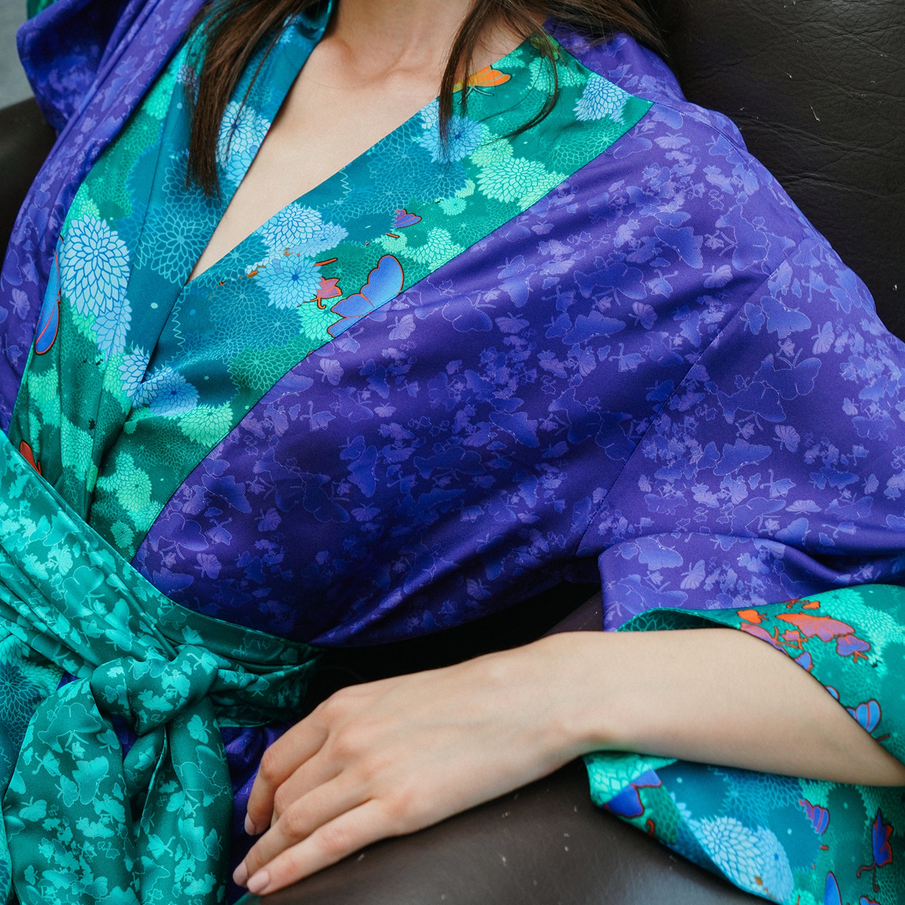 Silk kimono robe by karma on the rocks in Violet-niwa-teal. Front view closeup on model.