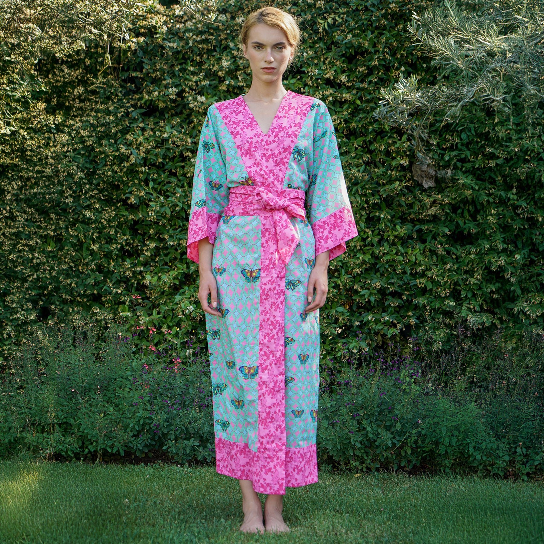 Kaze aqua/chocho rose hot pink and turquoise printed cotton kimono wrap robe. Front view on model.