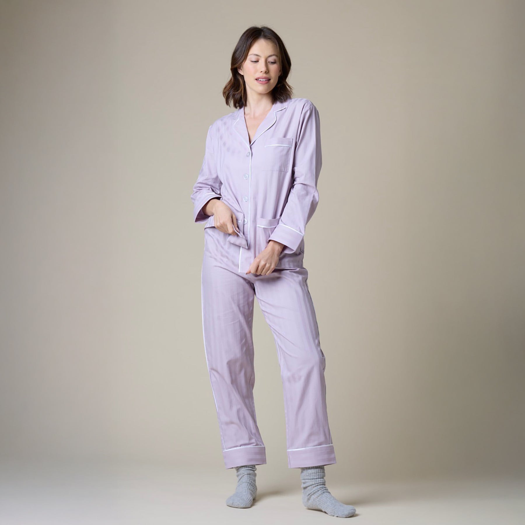 Lavender cotton classic pyjama set with contrast white piping. Front view on model.