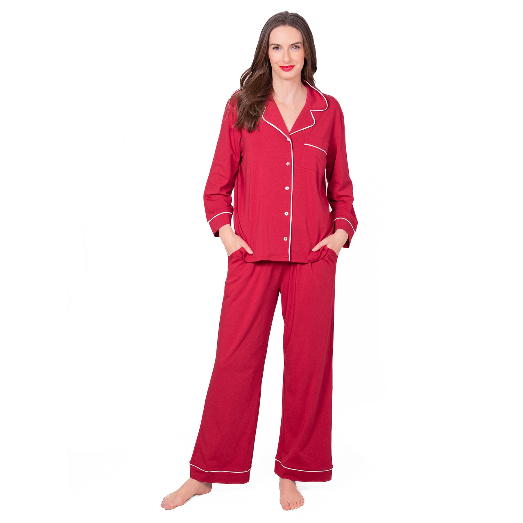 Woman wearing LatteLove Jester Red pajama set with white piping and long sleeve button-up top.