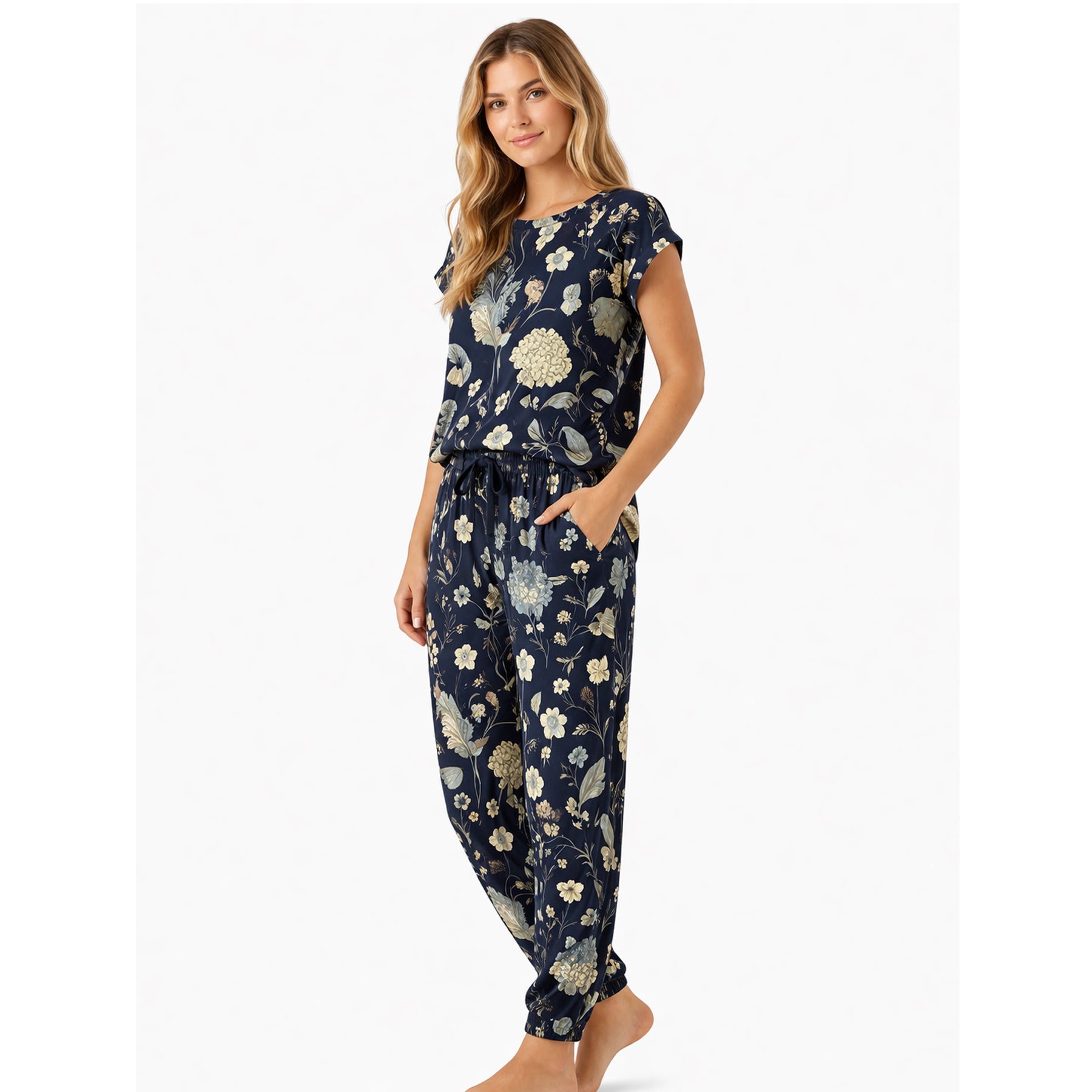 Navy botanical print pyjama set with short sleeve top and relaxed jogger pants, soft floral pattern, model standing in angled pose