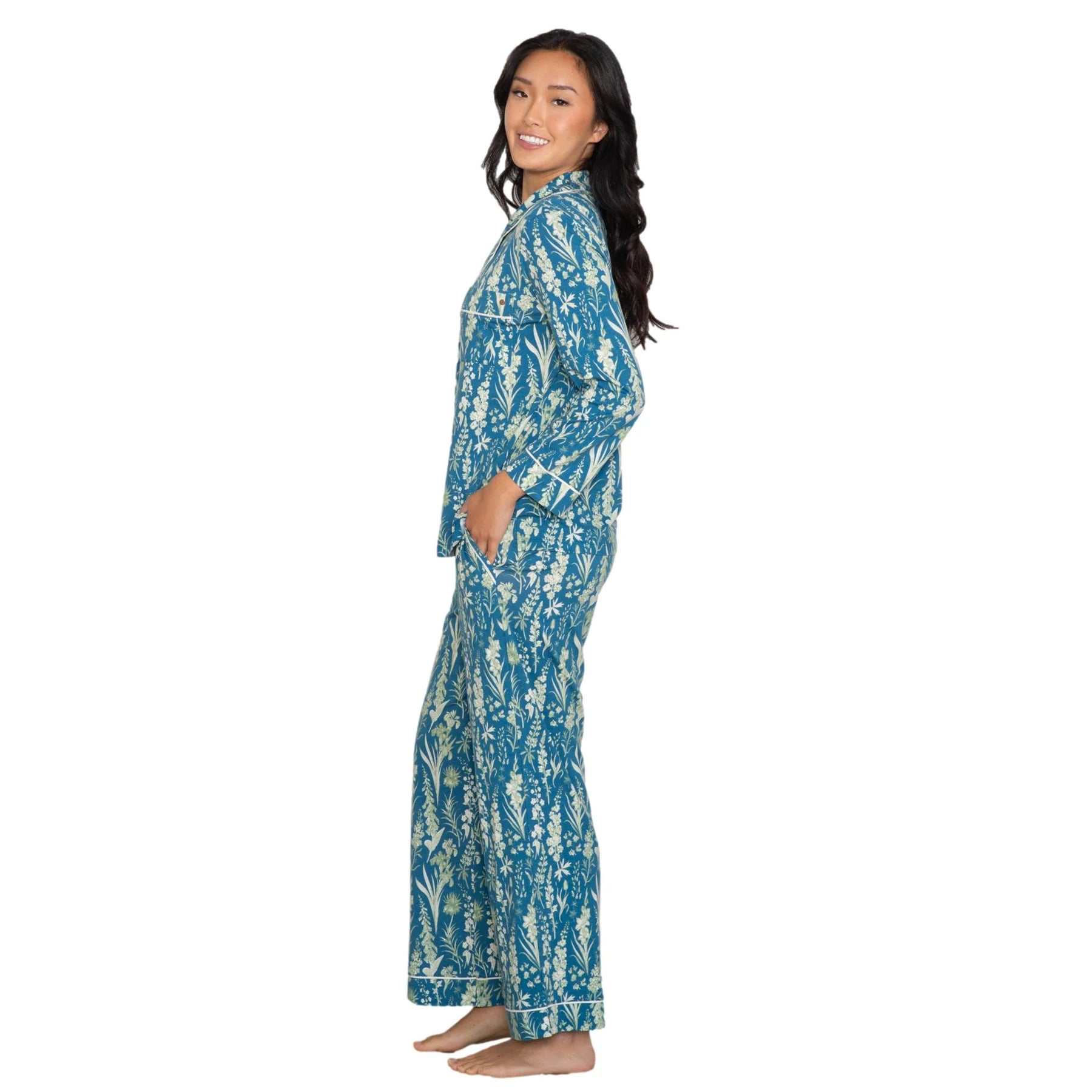 Teal botanical print pyjama set with contrast piping, long sleeve top and relaxed fit pants, side view on model