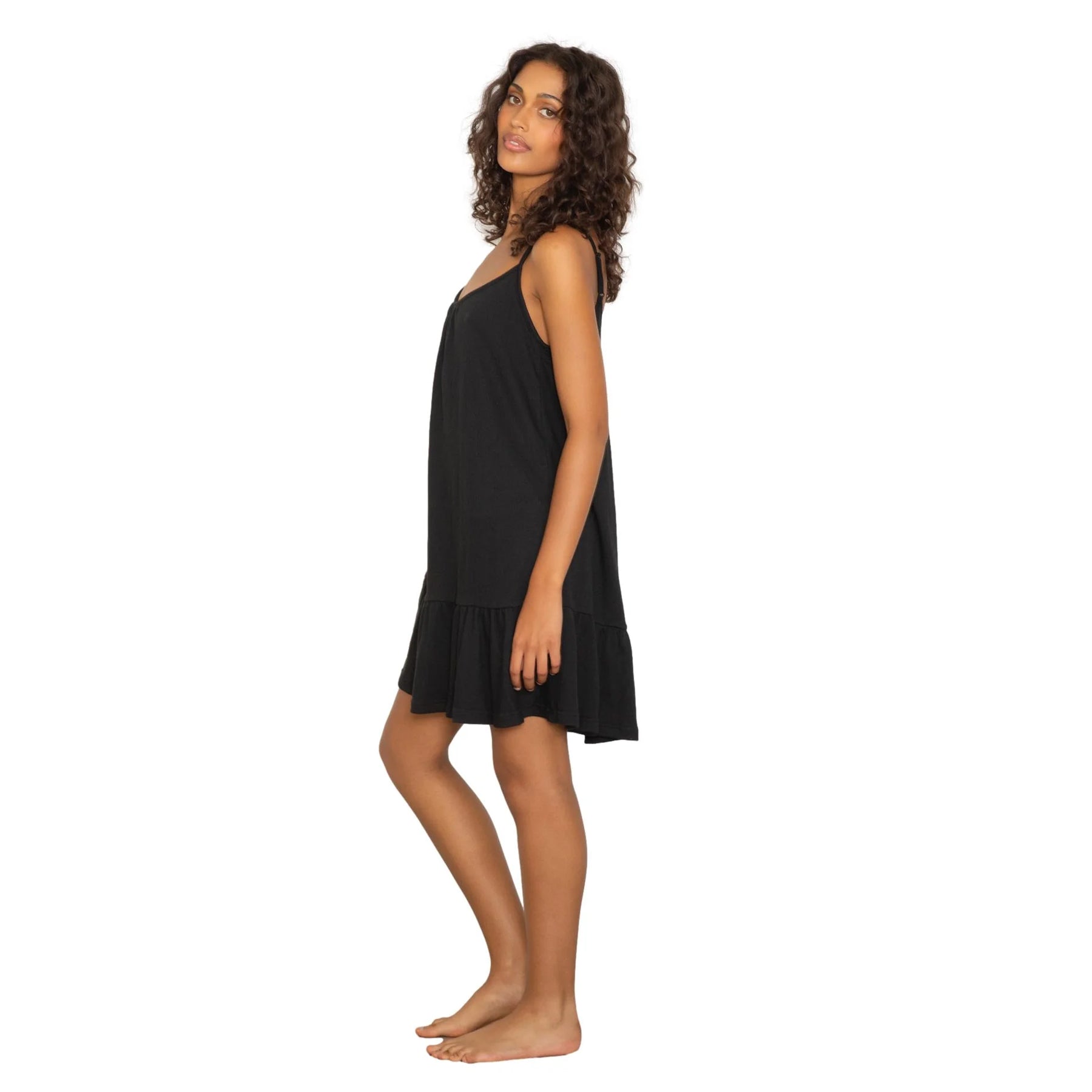 Lightweight black camisole dress with soft drape and flowy shape, side view on model