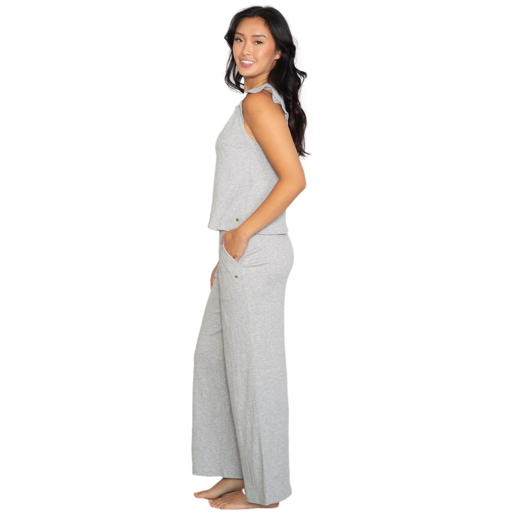 Grey sleeveless lounge set with ruffled cap sleeves and V-neck top, paired with wide-leg pants, side view on model