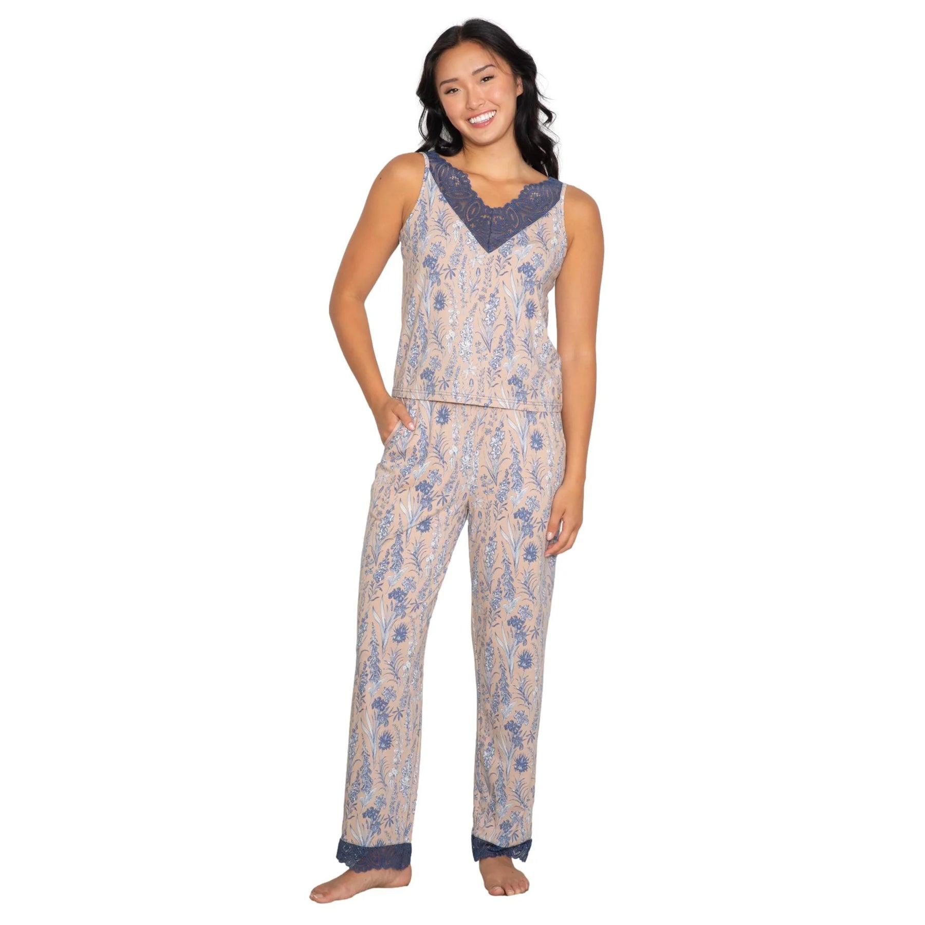 Woman standing in a blue floral print pajama set with lace trim neckline and hem, relaxed fit sleepwear set on white background