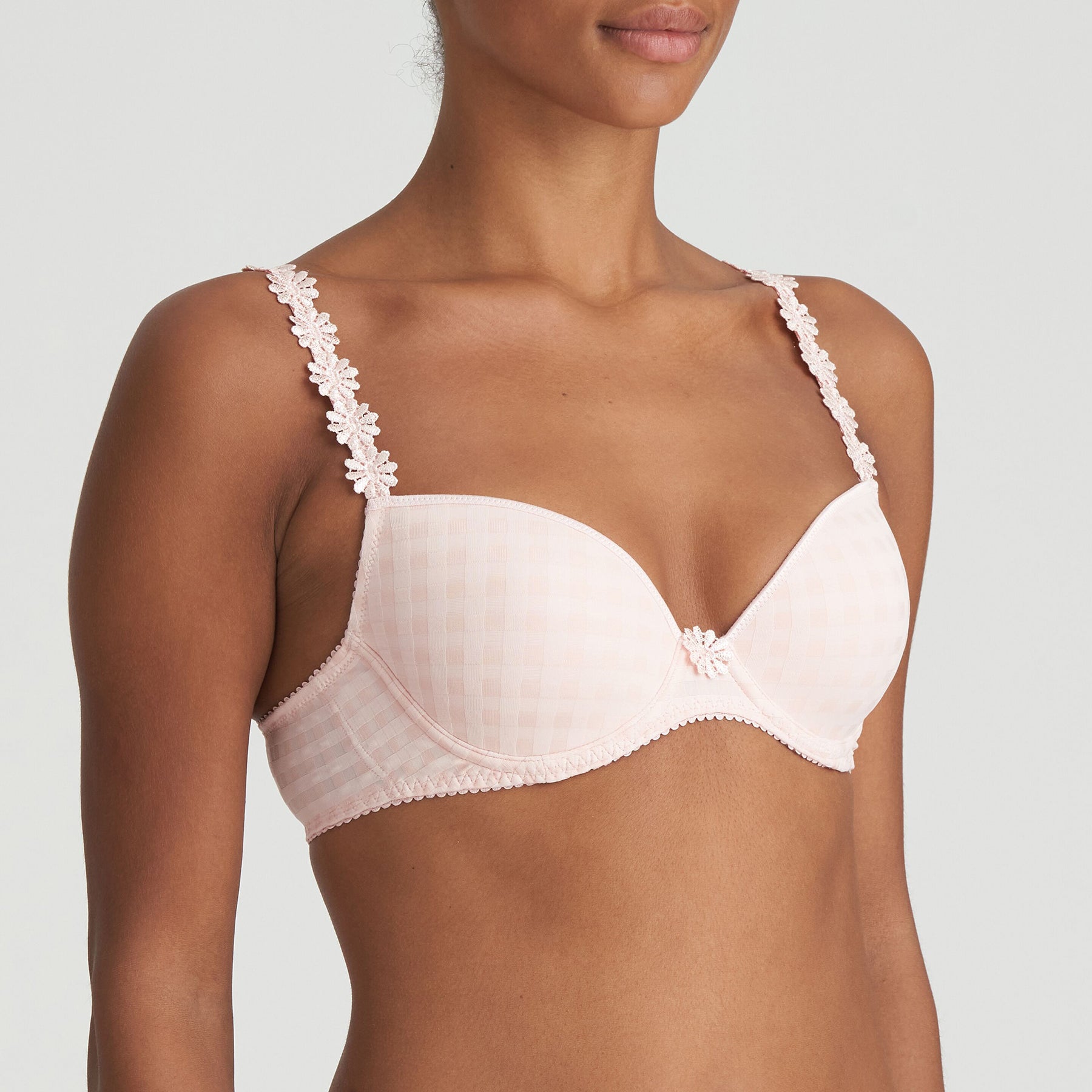 Padded plunge bra in pearly pink with checkerboard print and embroidered daisy straps. Side view on model. 