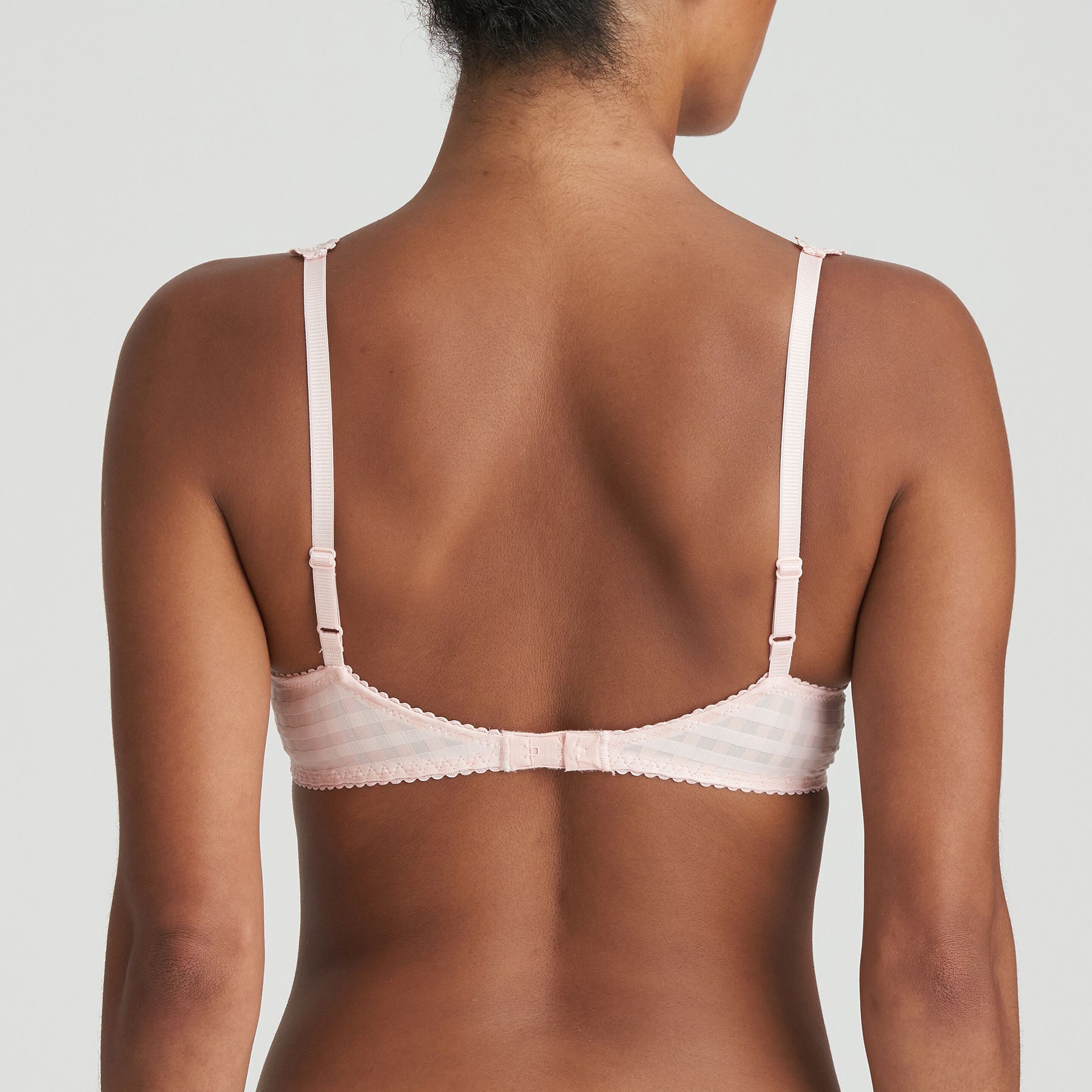 Padded plunge bra in pearly pink with checkerboard print and embroidered daisy straps. Rear view on model. 