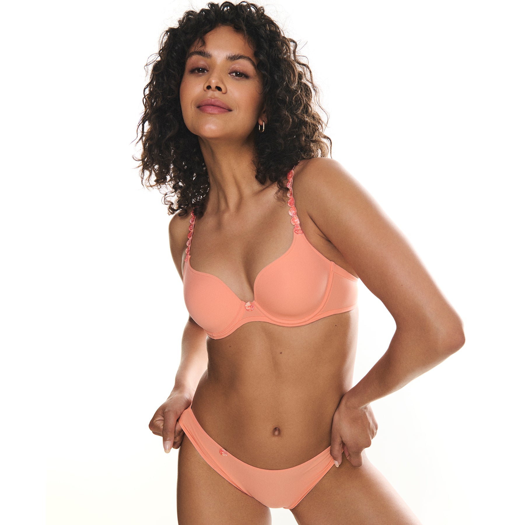 Seamless rio bikini brief in papaya smoothie light orange, shown with matching heart shaped bra. Front view on model. 