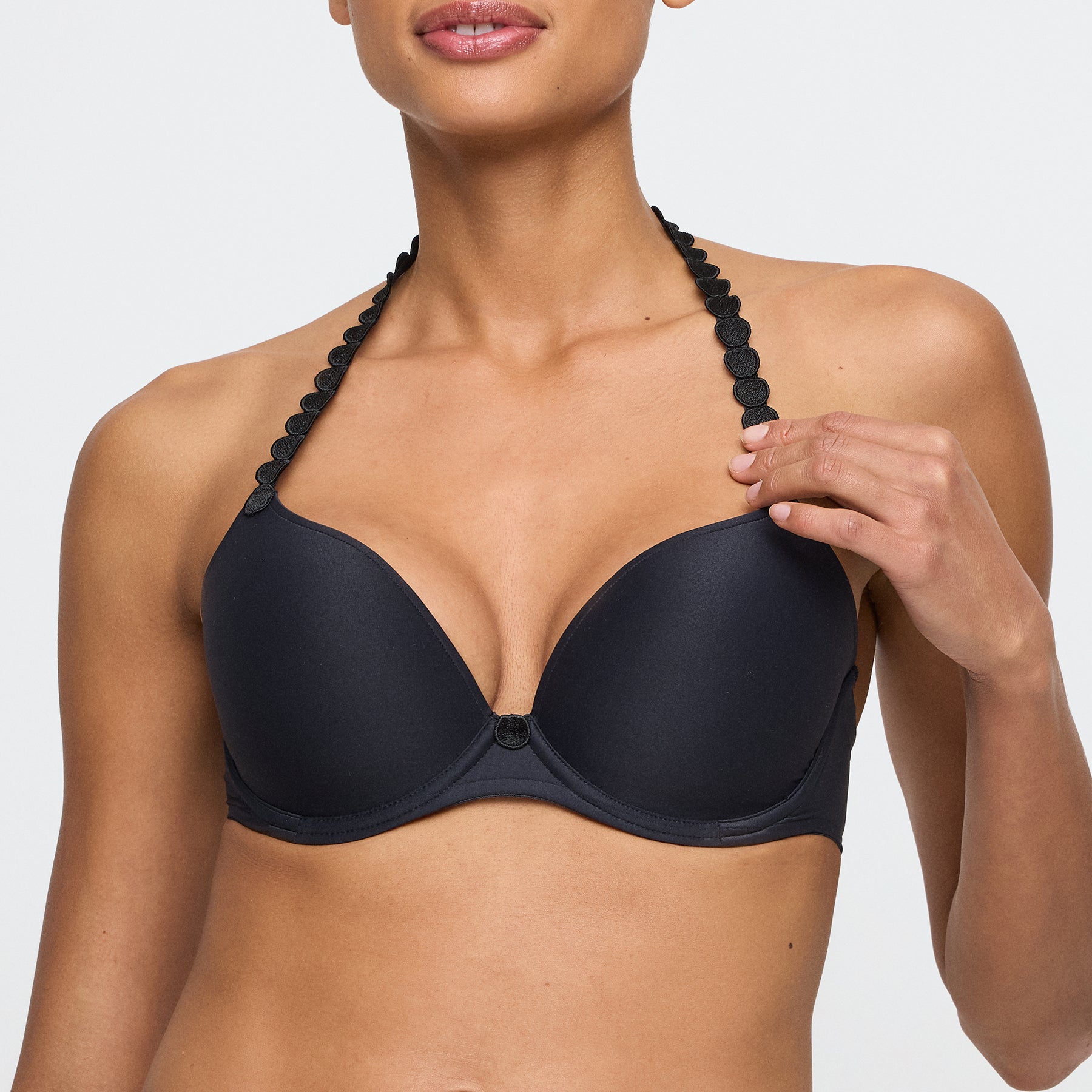 Model adjusting Marie Jo Tom Push-Up Bra in Charcoal Black - close-up
