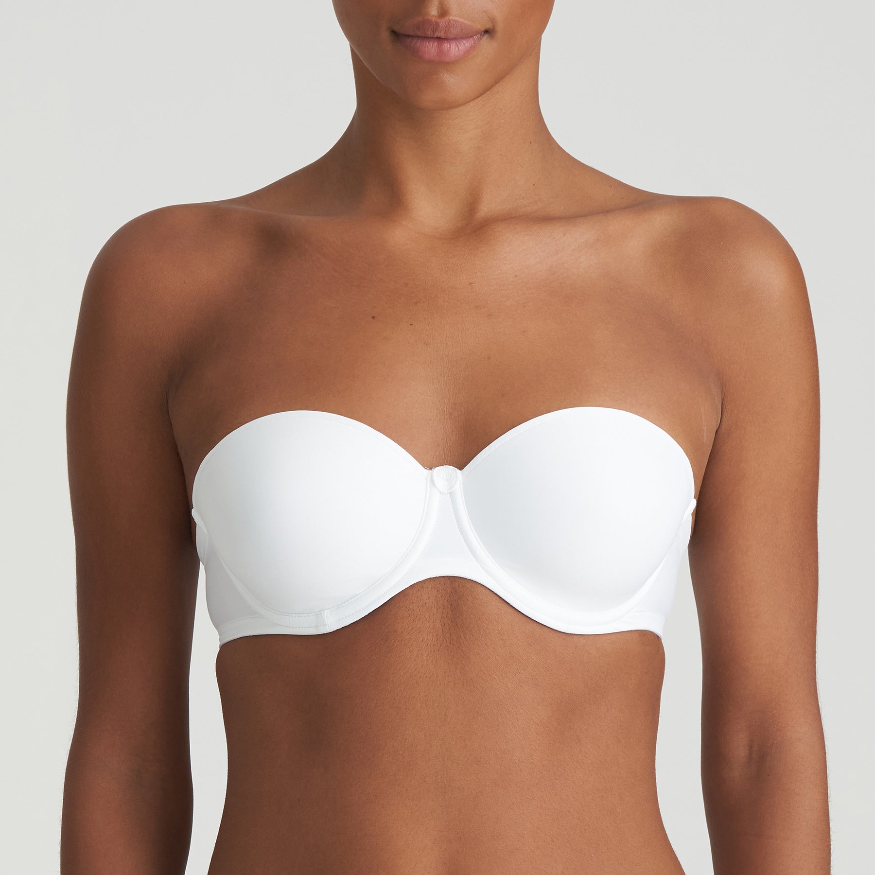 Model wearing Marie Jo Tom Strapless Bra in White – everyday padded underwire bra with a seamless finish, shown without straps.