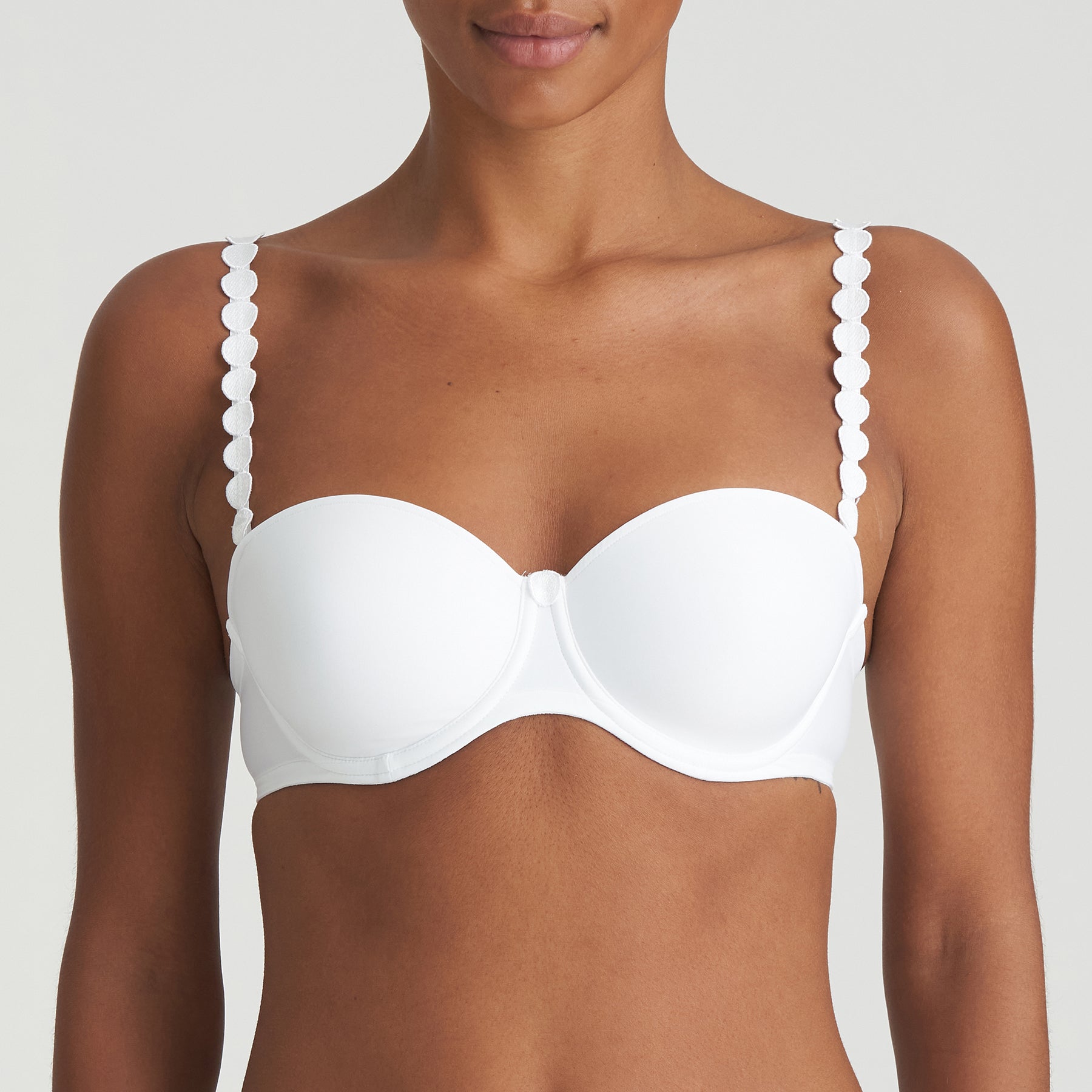 Model wearing Marie Jo Tom Balcony Bra in White – comfortable padded underwired bra with signature circular strap design and smooth shaping.