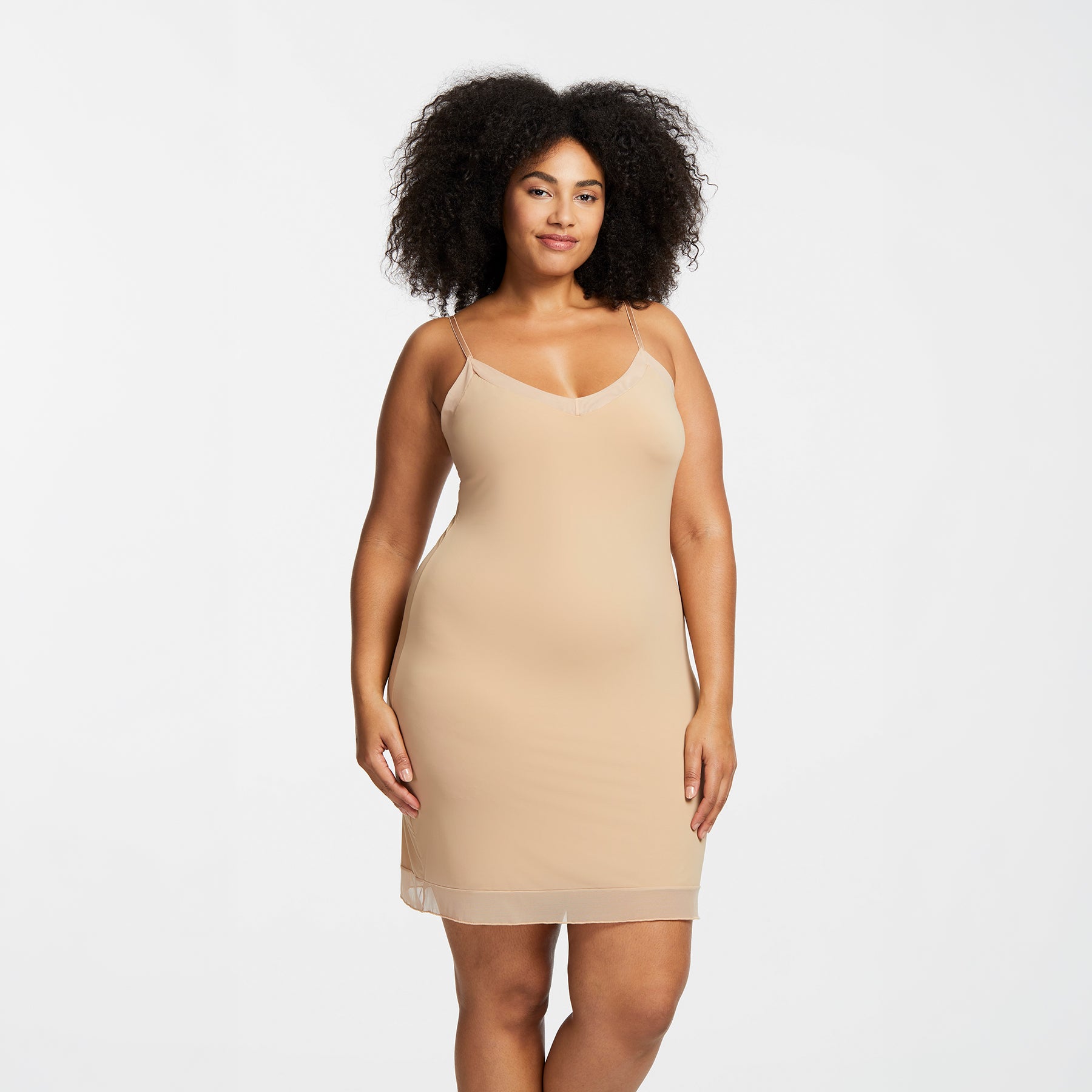 Montelle Intimates 9500 V-neck slip at knee in Sand colour with lightweight smoothing fabric and elegant V-neckline, front view on curvy model.