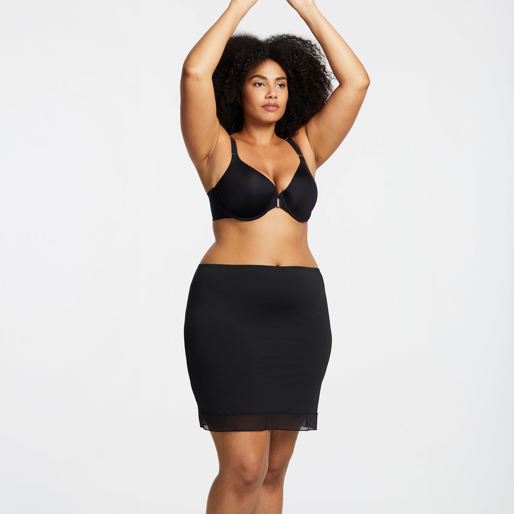 Montelle Intimates 9502 18-inch half slip above knee in Black colour with lightweight seamless design and sheer trim, front view on curvy model.